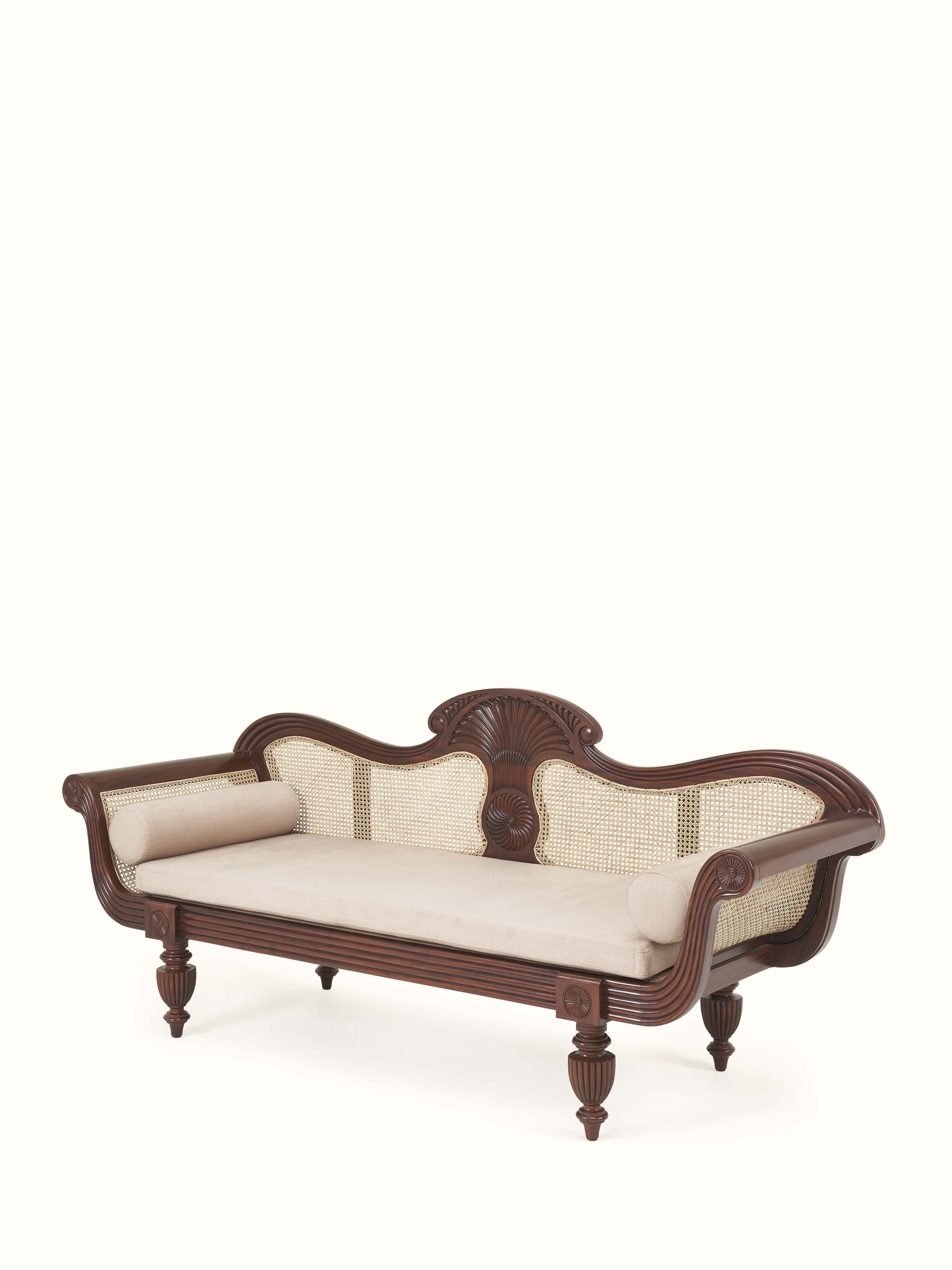 Angle view of upholstered Mahogany wood and cane 3-seater sofa focusing on blended traditional and modern styling