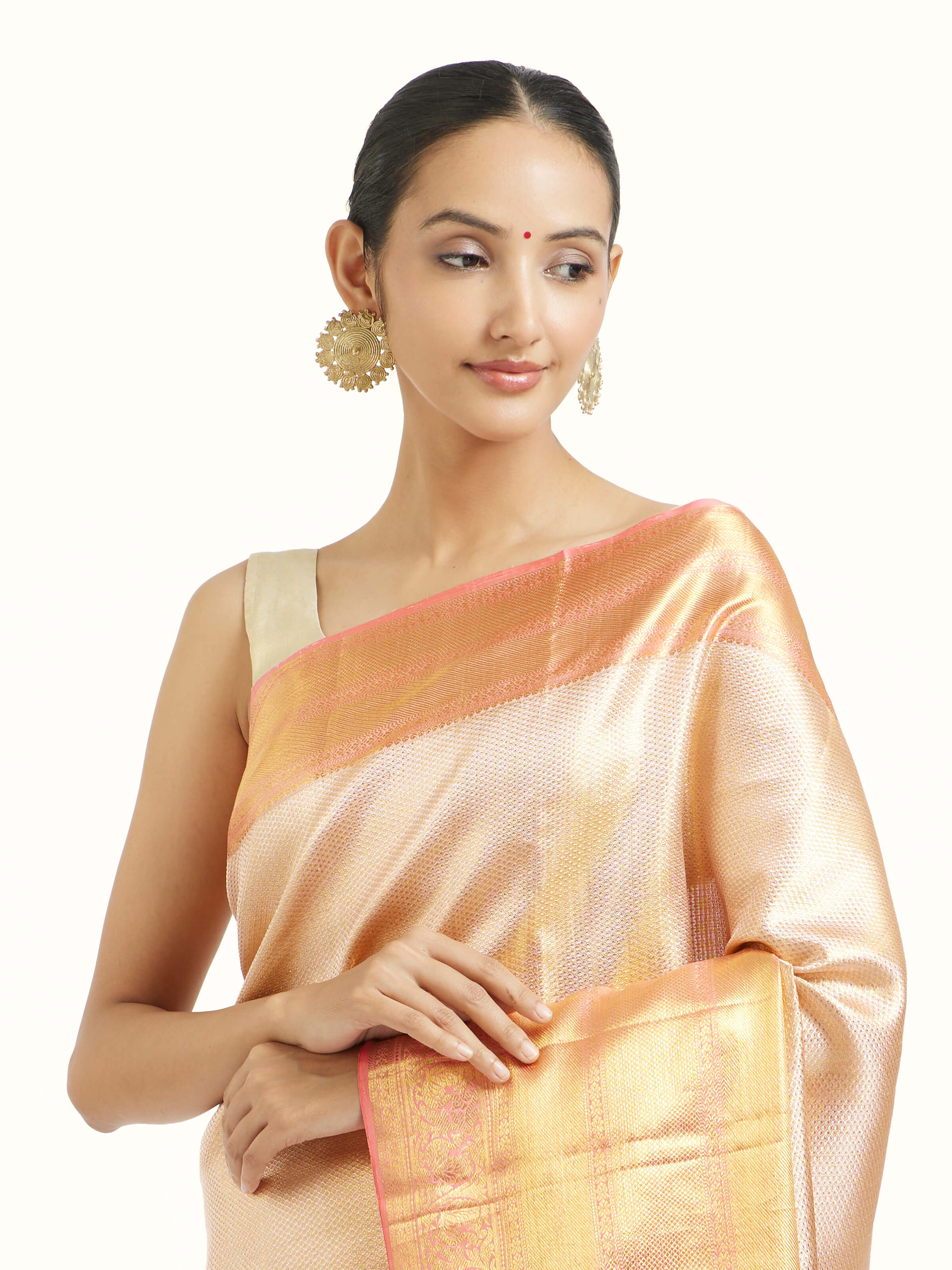 Angled view of beige silk Kancheepuram saree highlighting traditional weave