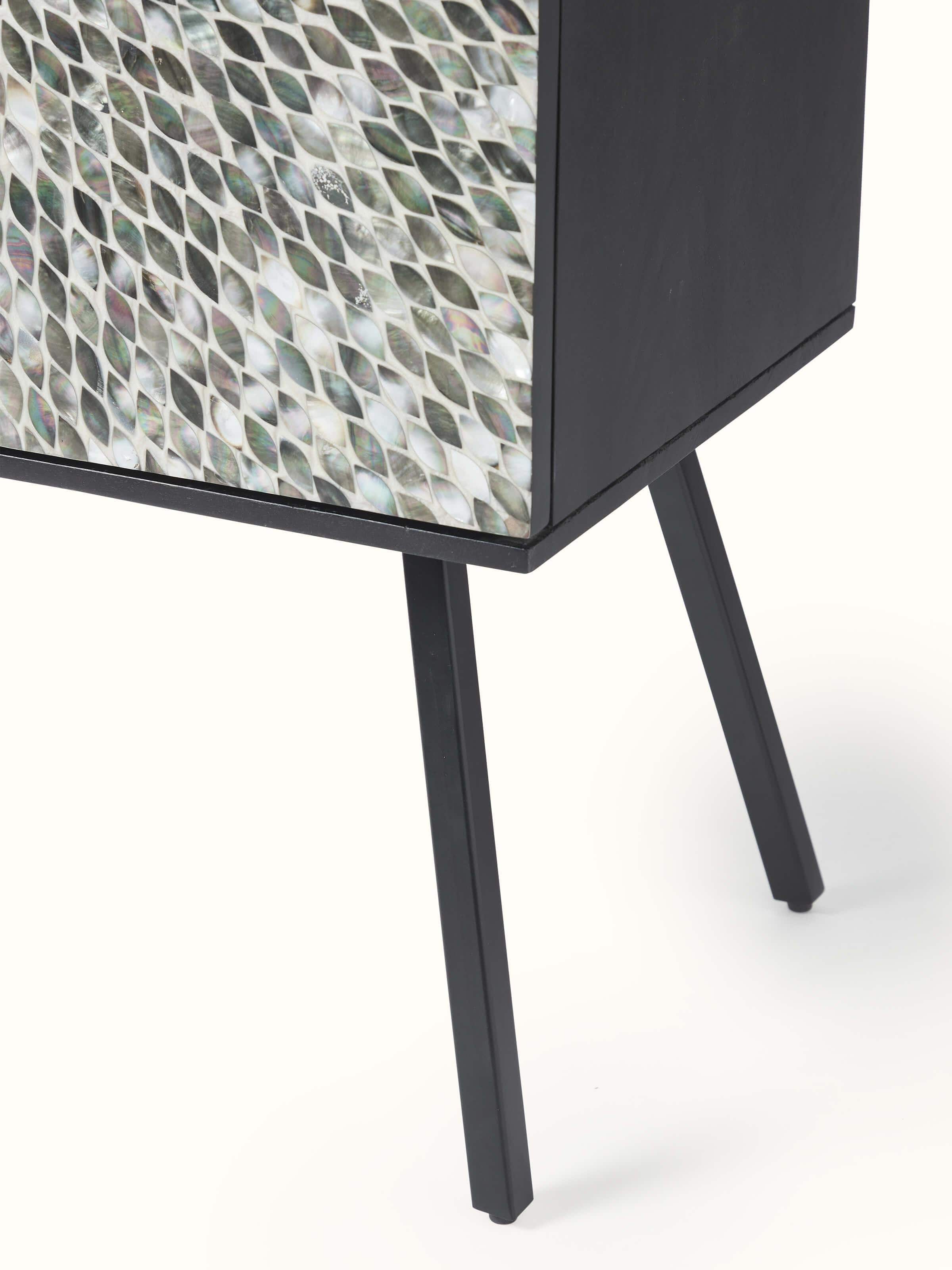 Close-up of the bar cabinet’s base with mother-of-pearl inlay on mango wood, highlighting the fine details and finish