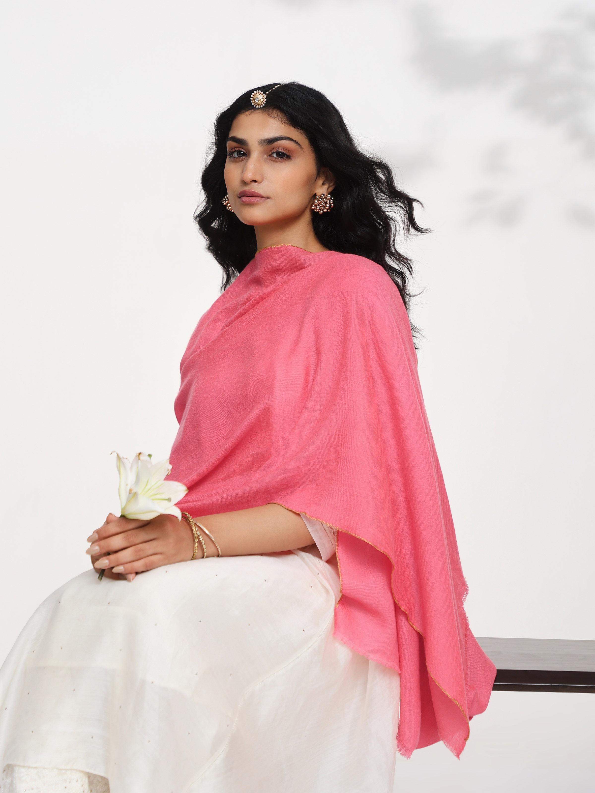 Angled view of coral cashmere kaaj embroidered handwoven stole highlighting handcrafted embroidery