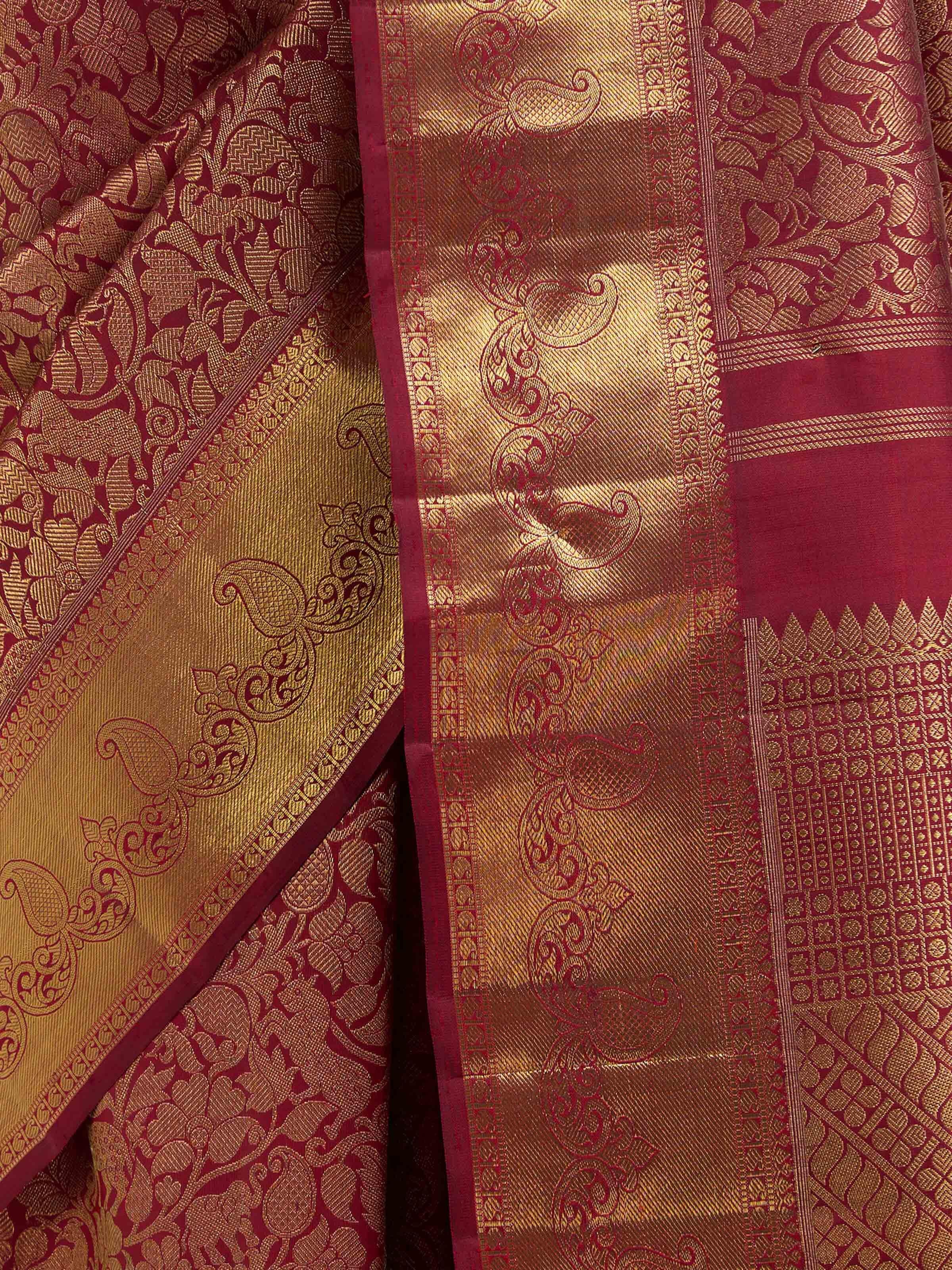 Detail view of light pink silk Kancheepuram saree showing zari work