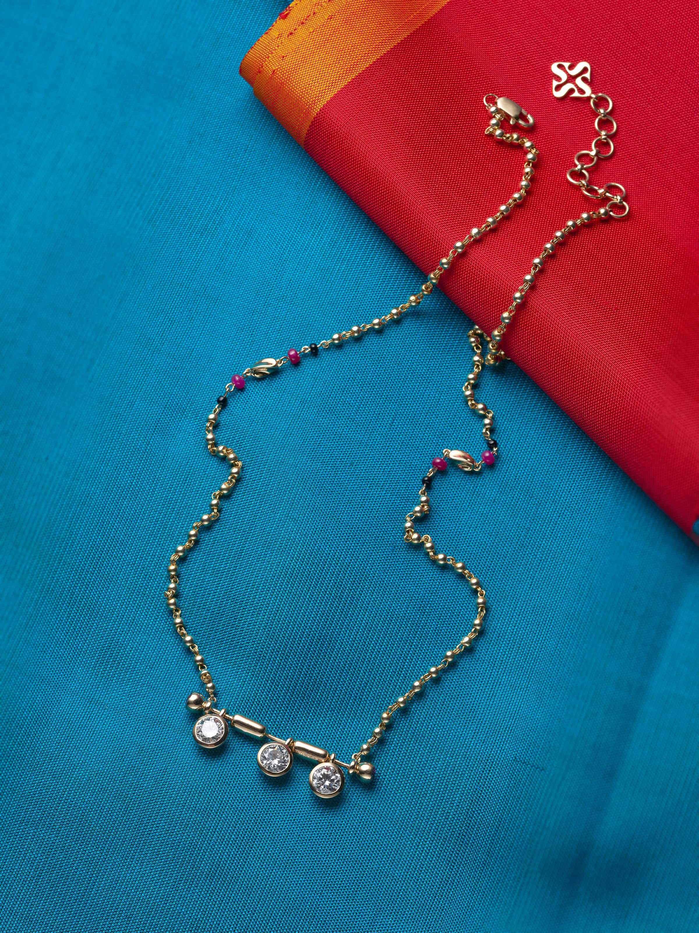 lifestyle view of open setting 14 karat gold mangalsutra