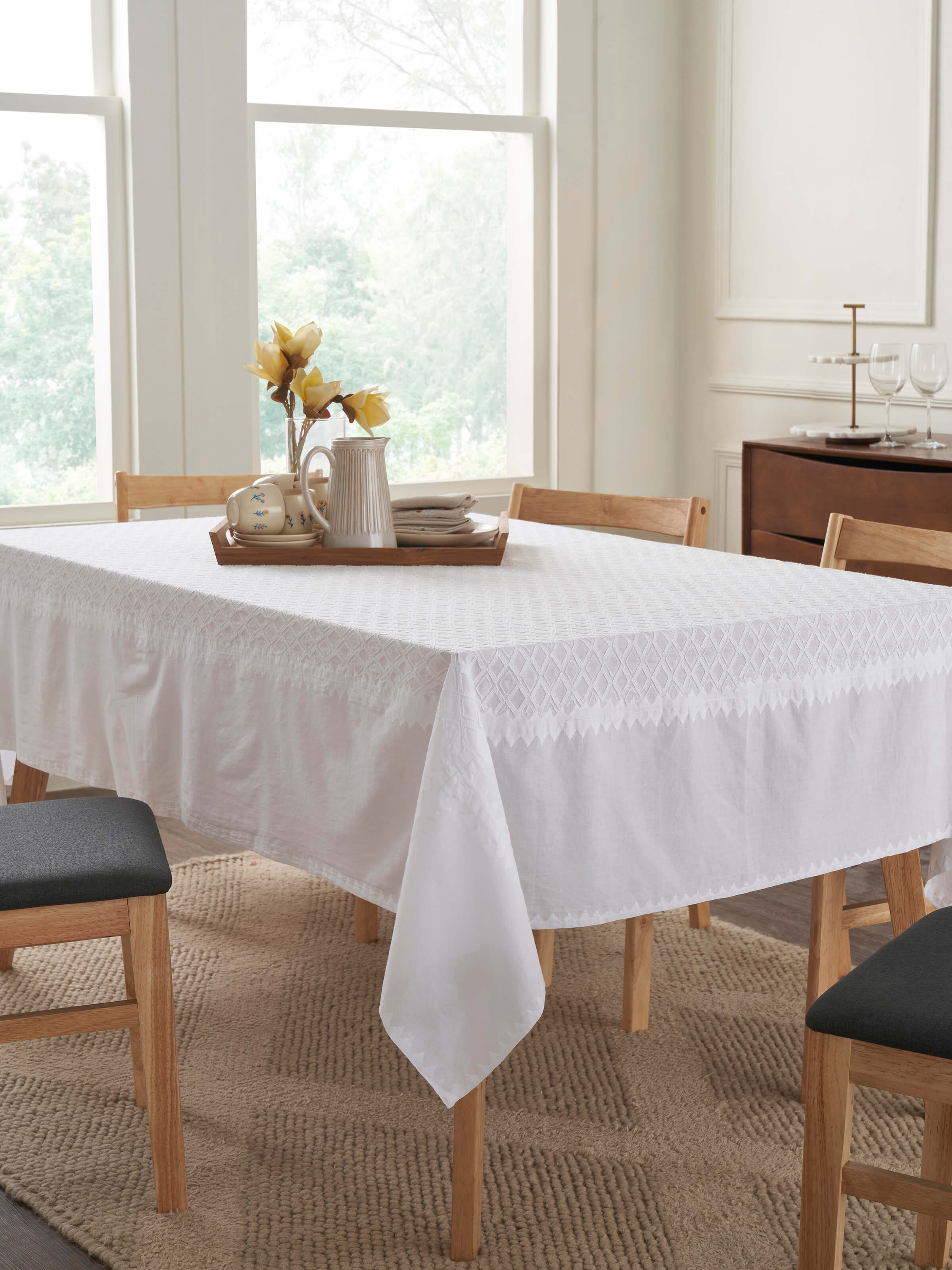 Lifestyle image featuring Ananda White Chikankari Cotton Table Cover styled on a dining table