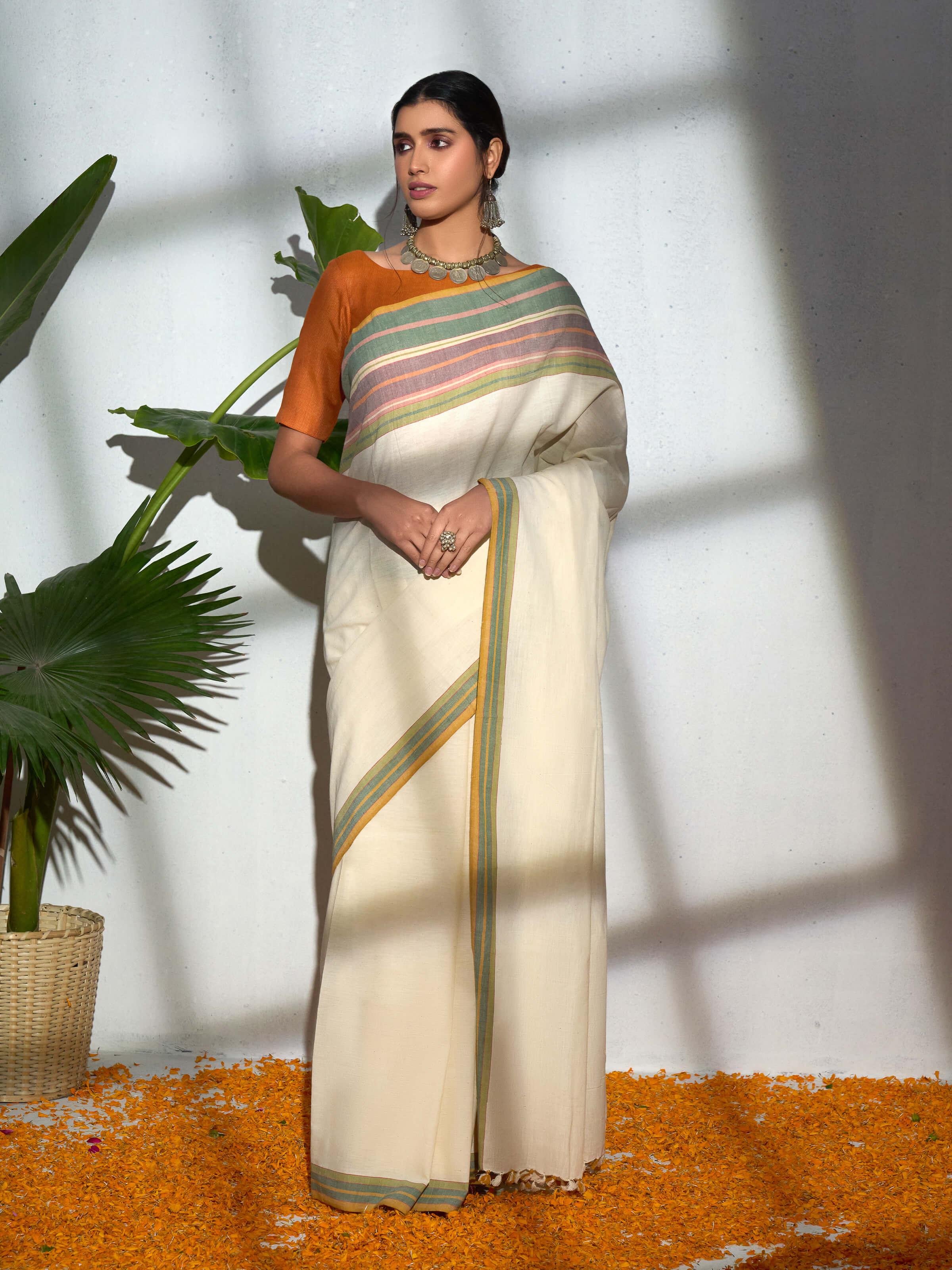 Side view of cream cotton hand-spun striped saree showcasing lightweight texture