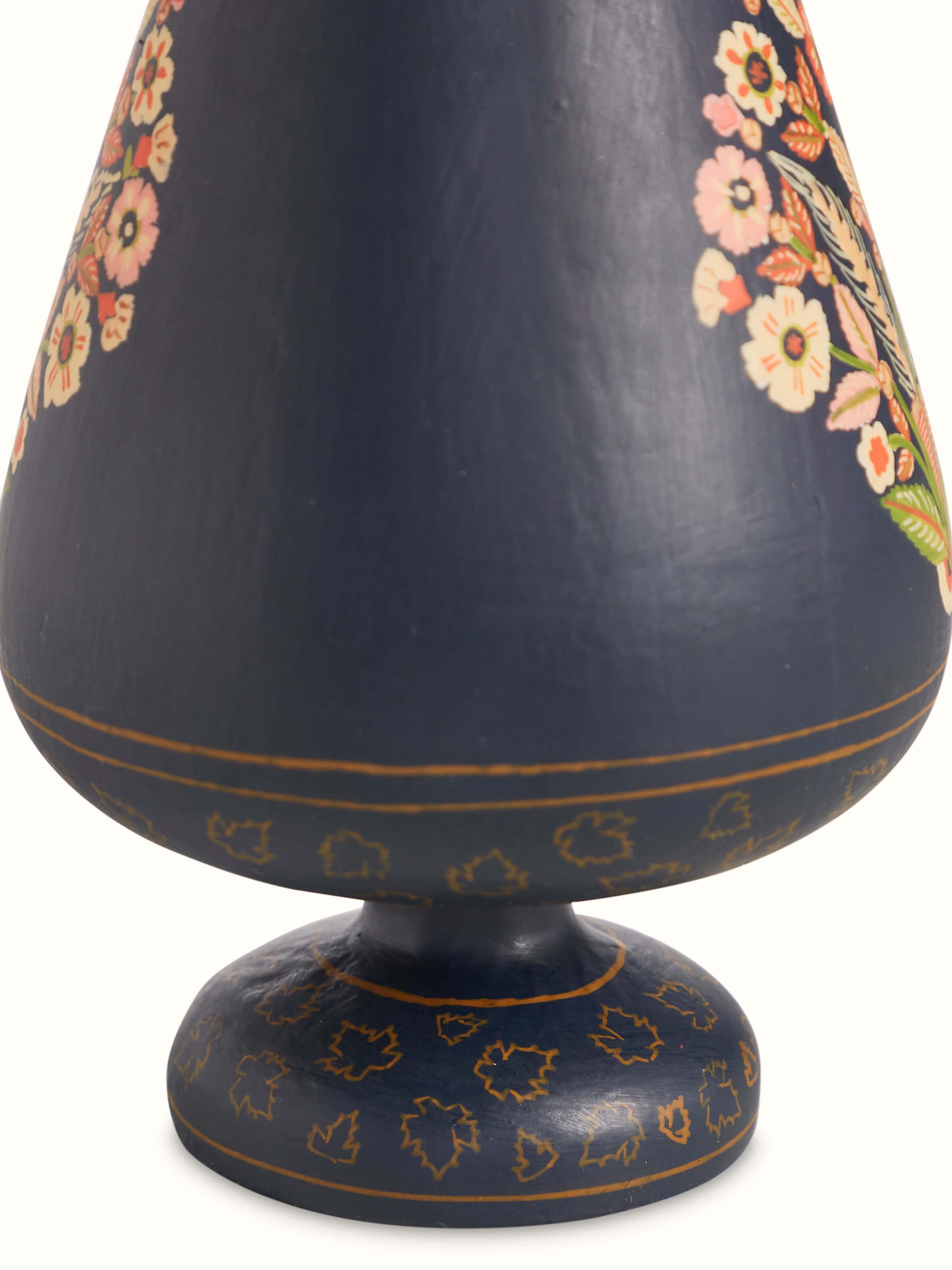 Close-up view of Papier-mache table vase in multicolor focusing on artistic details