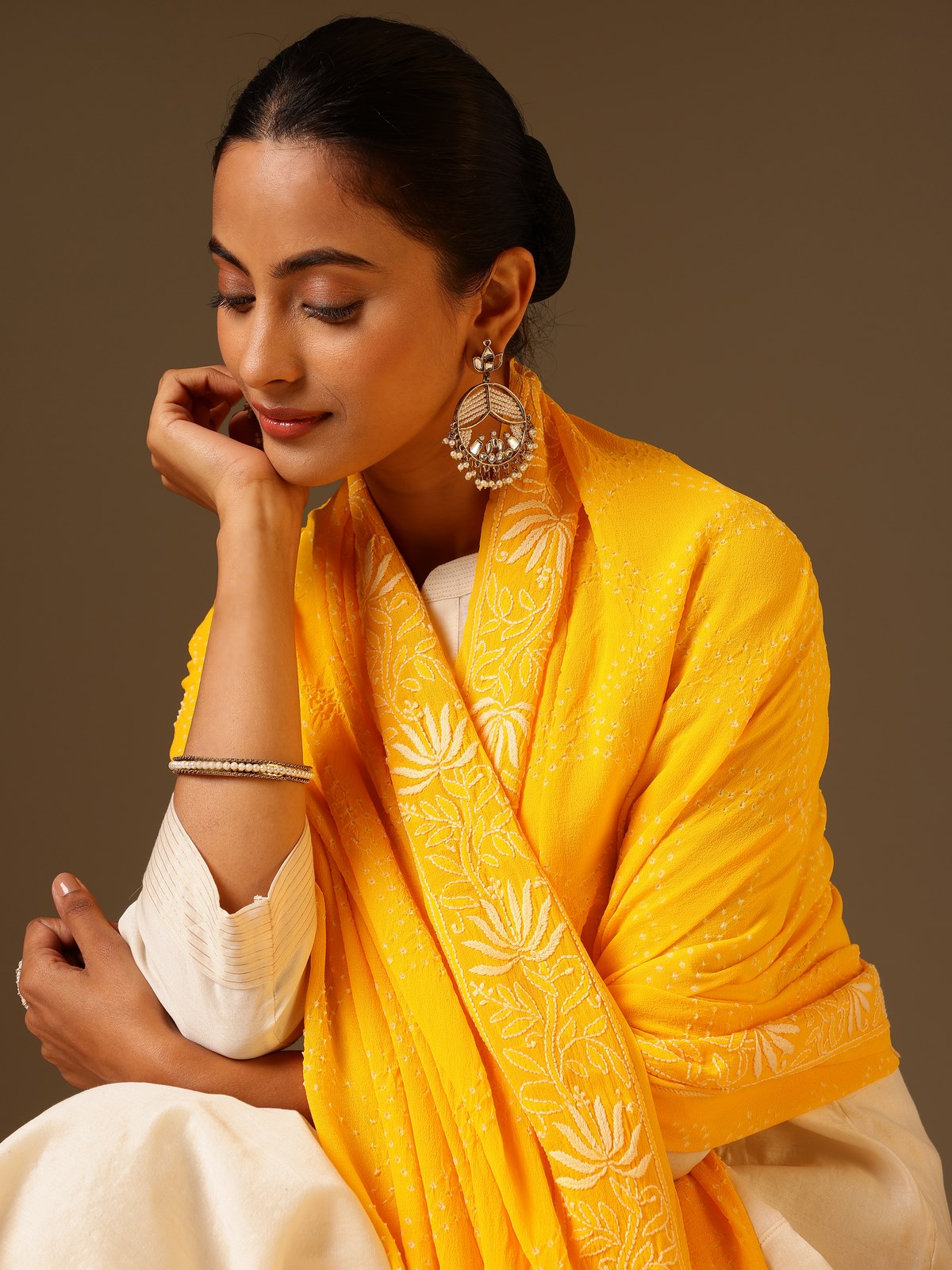 Detail view of yellow georgette bandhani tie and dye dupatta showing fabric texture