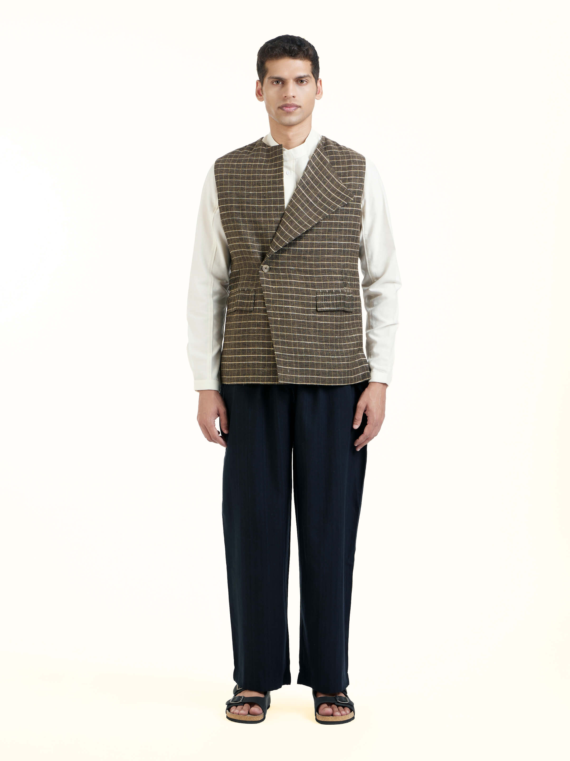 Front view of brown handloom sleeveless jacket with textured woven fabric