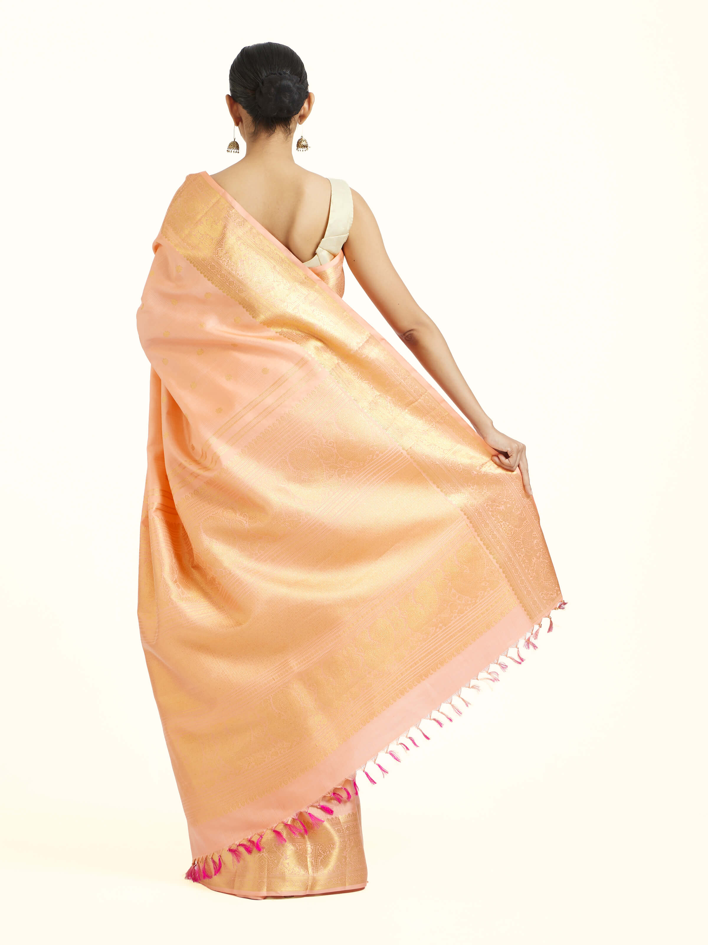 Back view of light pink silk Kancheepuram saree displaying ornate pallu design