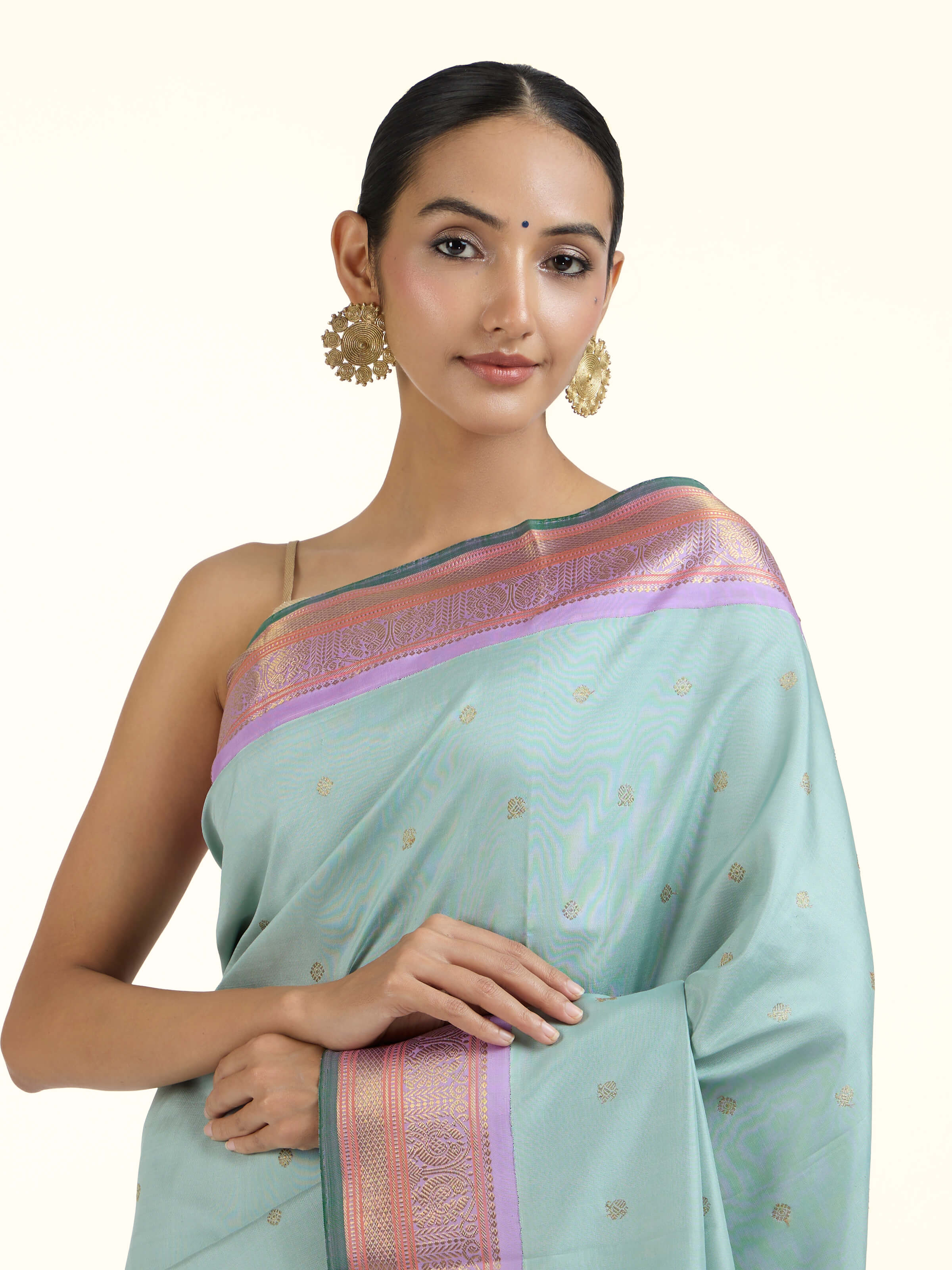 Angled view of light blue silk Kancheepuram saree highlighting traditional weave and sheen