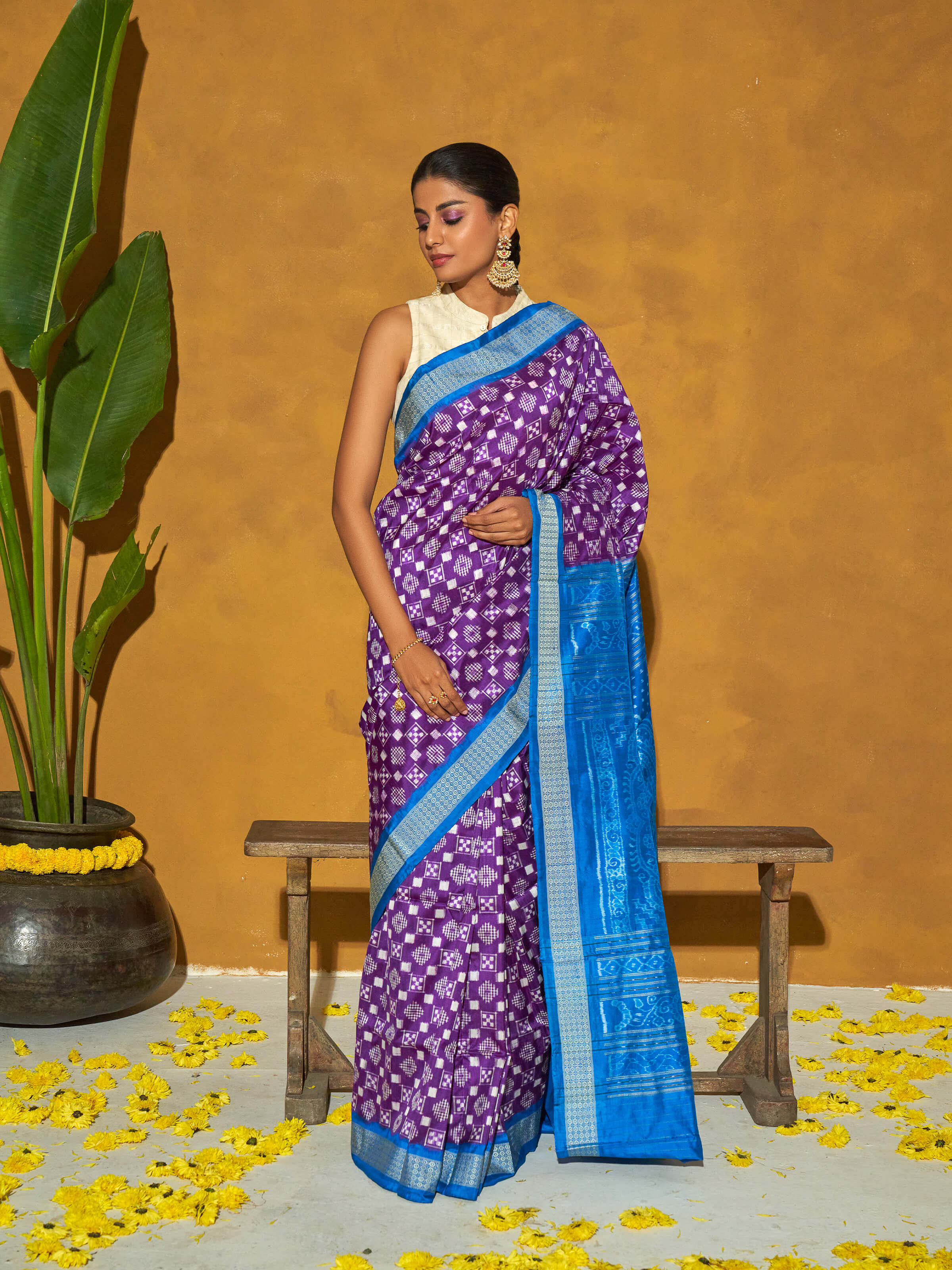 Side view of turquoise mulberry silk bandha Odisha ikat saree with graceful drape