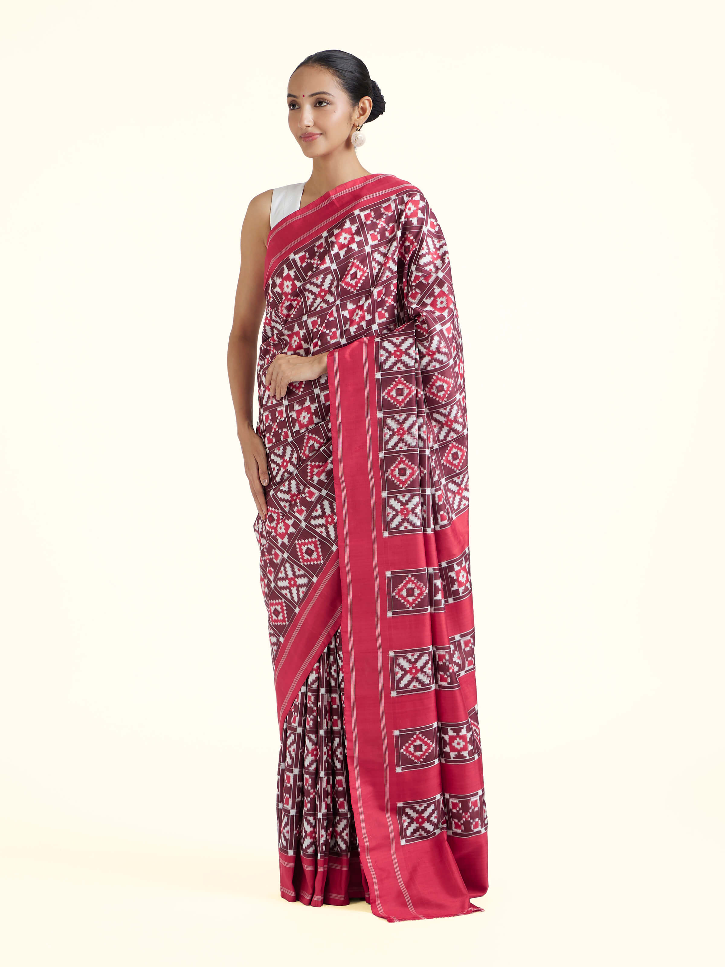 Side view of red mulberry silk Ikat saree highlighting graceful drape and woven detailing