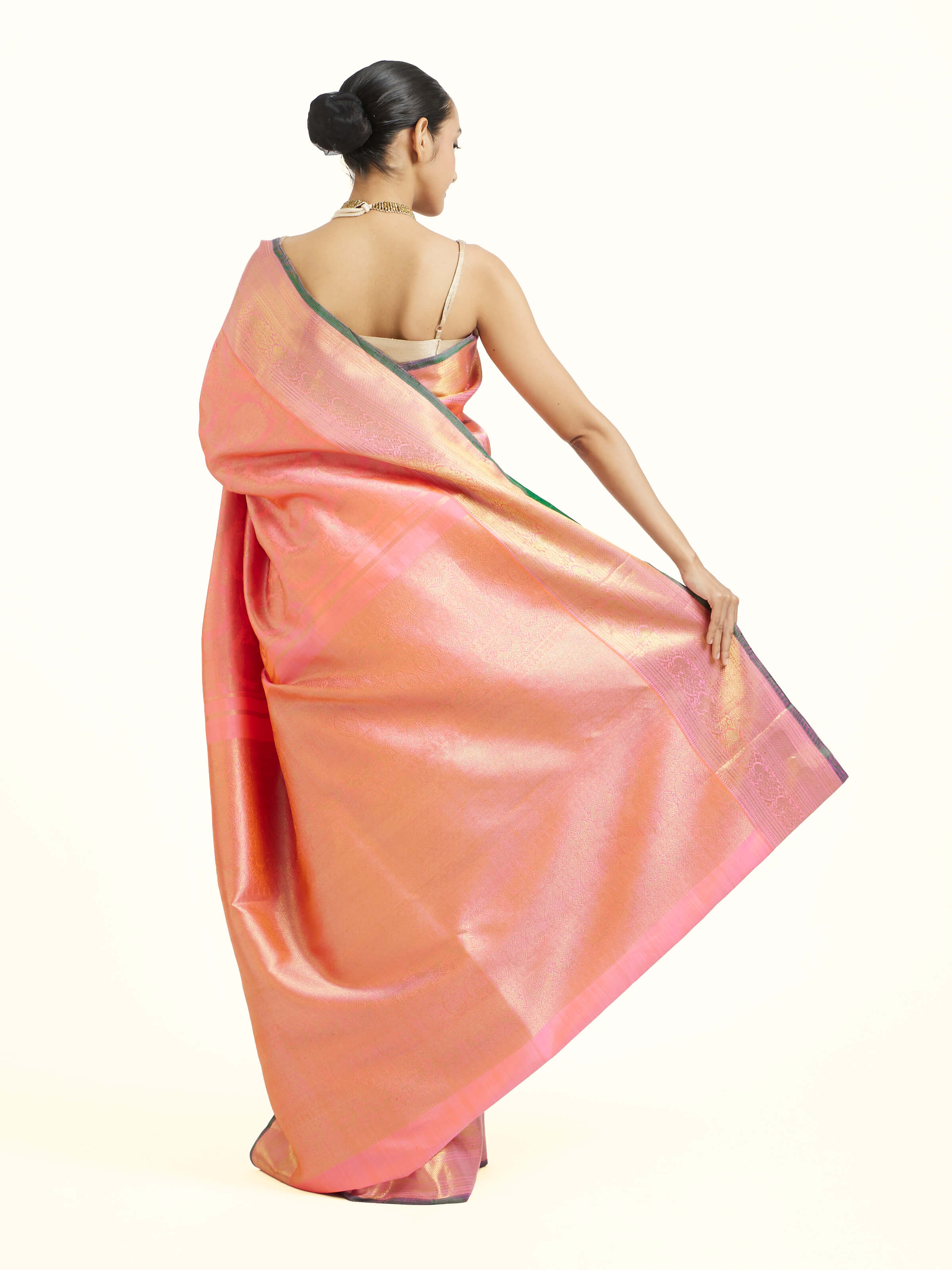 Back view of pink silk Kancheepuram saree displaying ornate pallu design