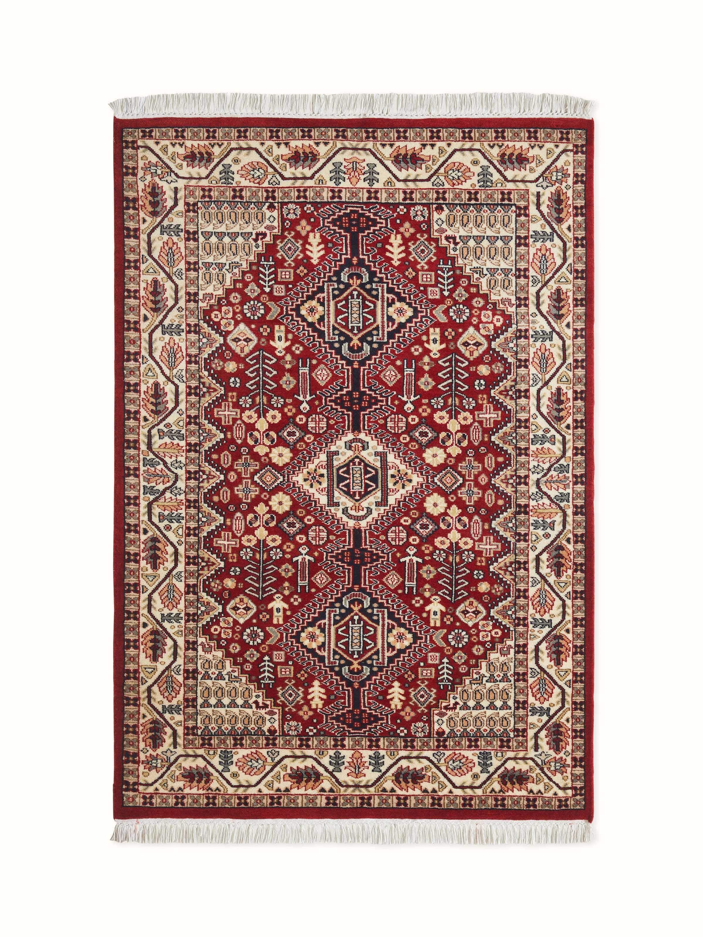 Full view of Persian-style Kazak carpet in rust tones, hand-knotted from Gwalior wool with bold tribal motifs