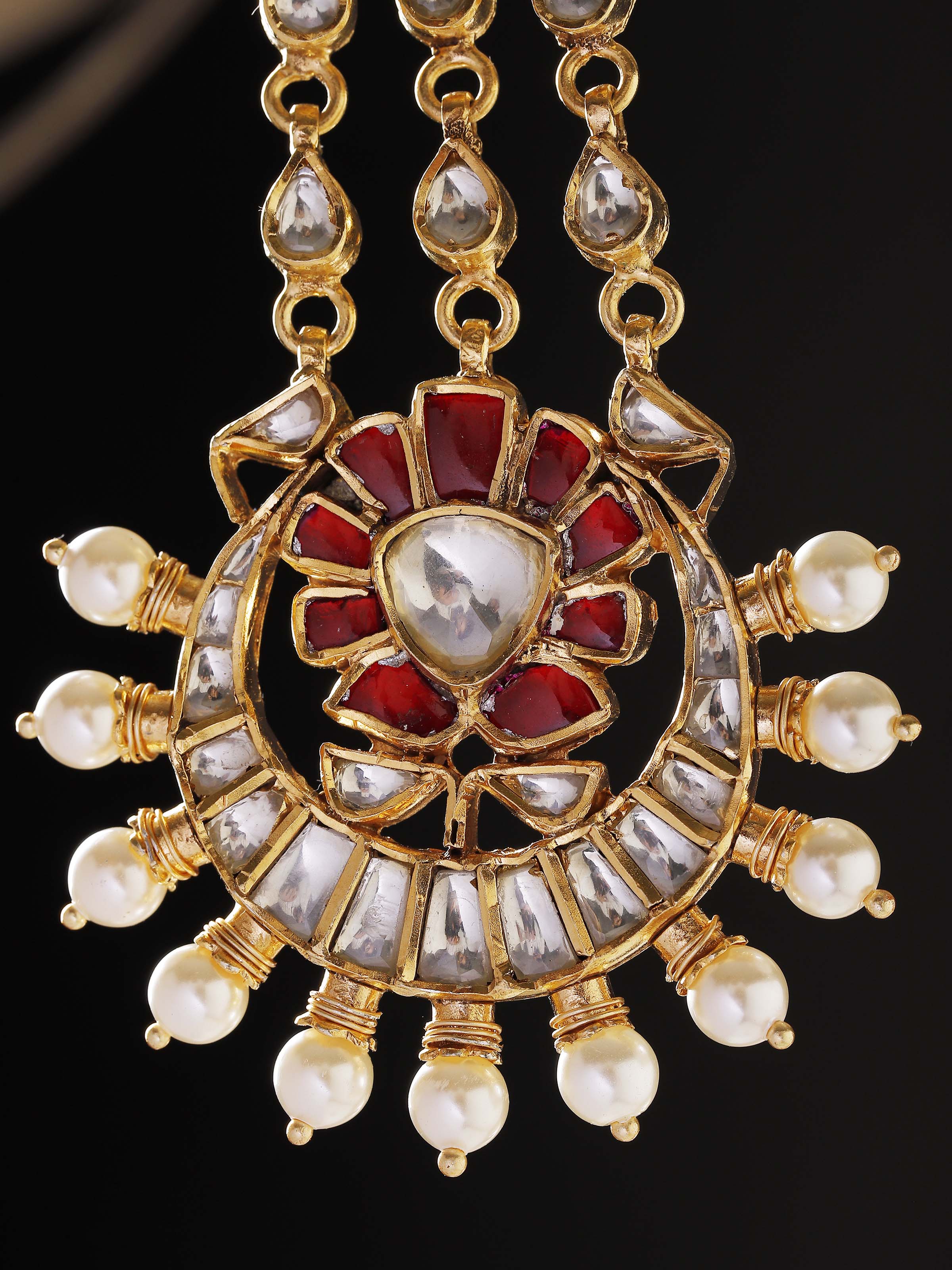 Close-up of handcrafted silver smithing detail on drop earrings