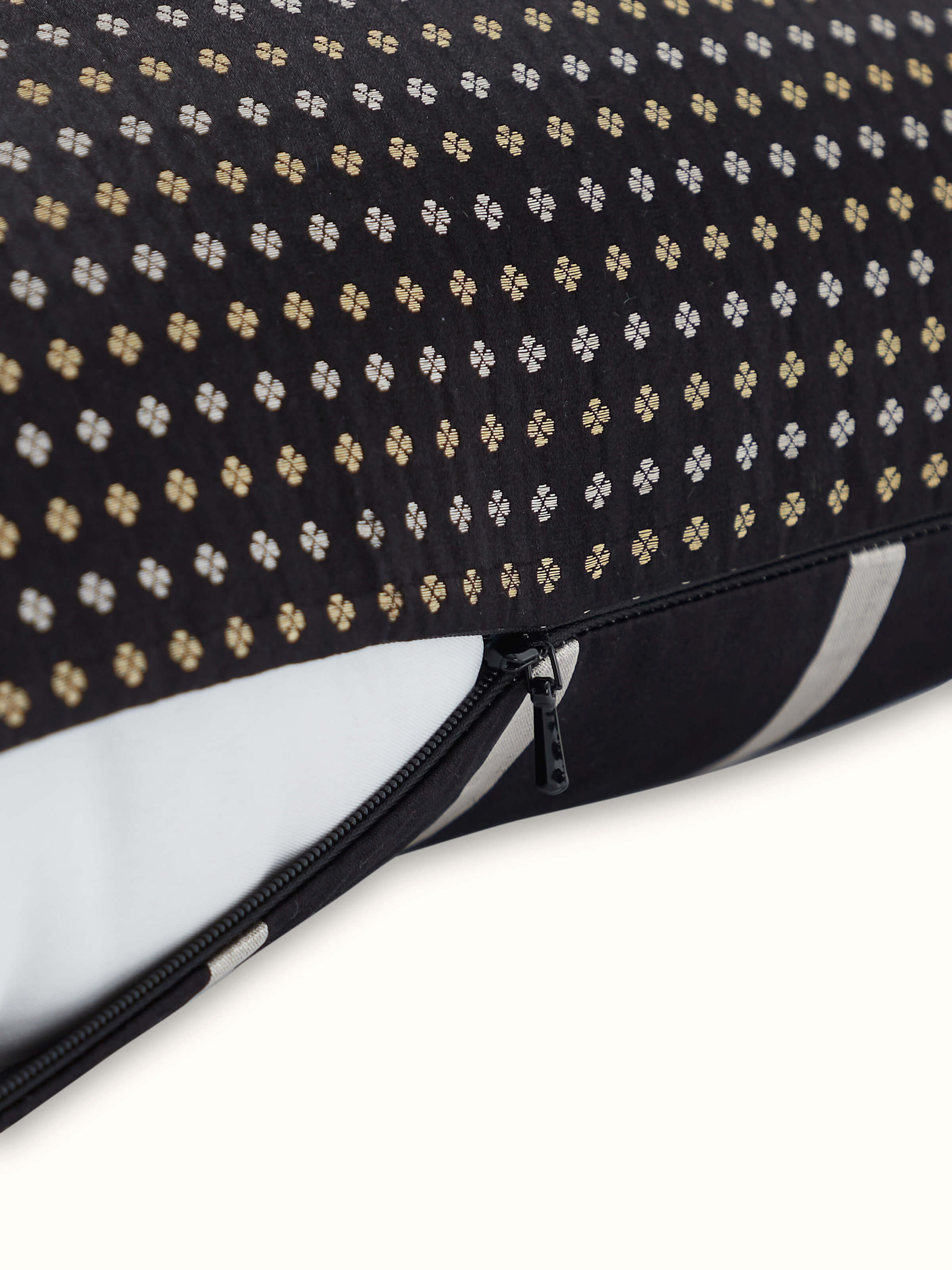 Angled view highlighting the sheen and texture of black striped Banarasi silk handloom cushion cover