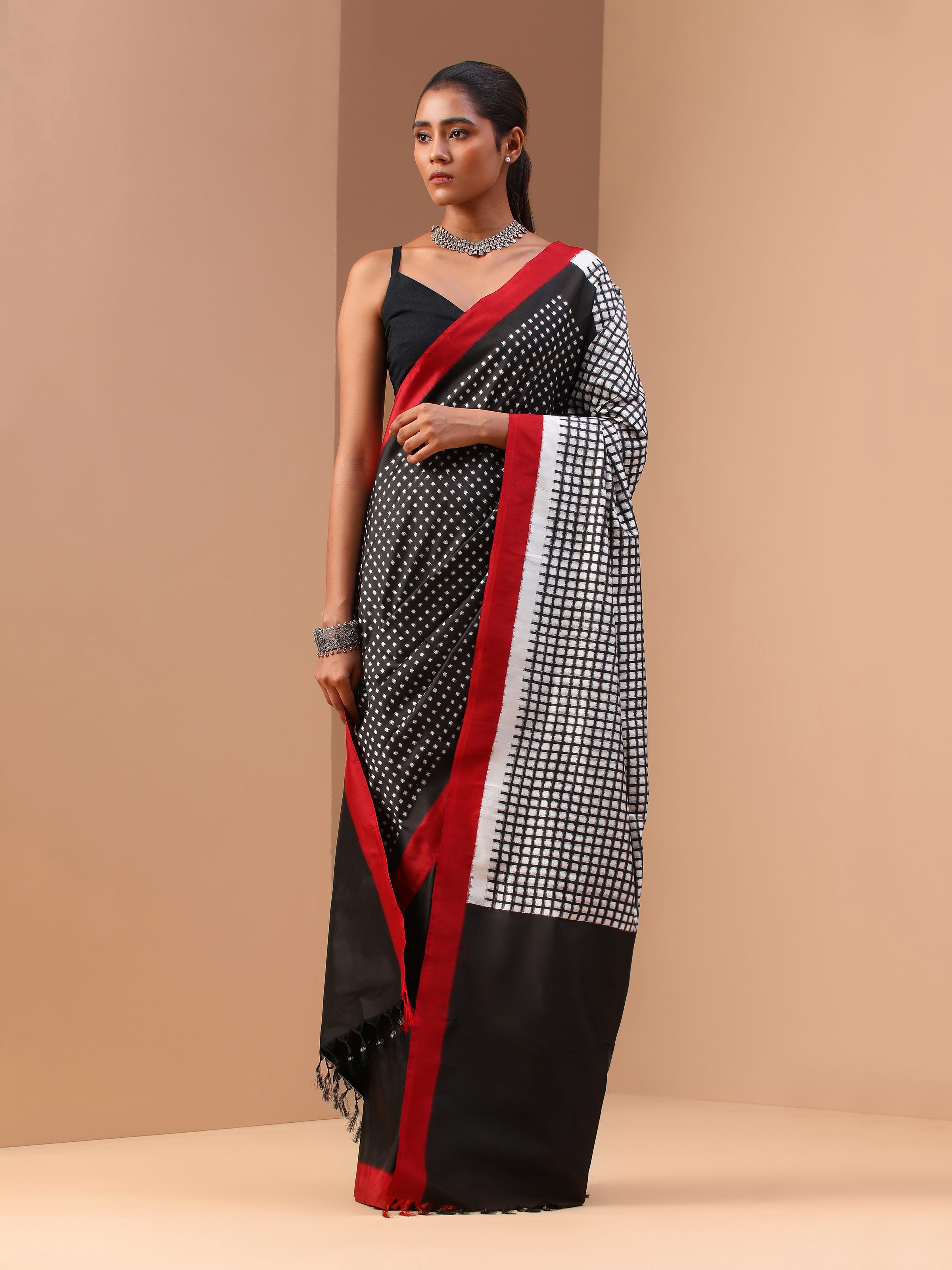 Lifestyle shot of black silk double ikat saree draped on model highlighting rich texture