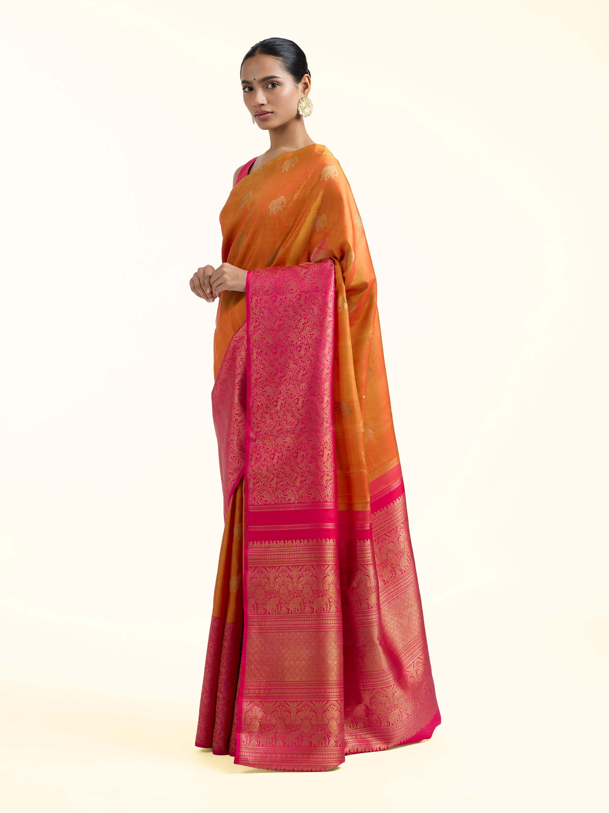 Side view of orange silk Kancheepuram saree showcasing silk sheen