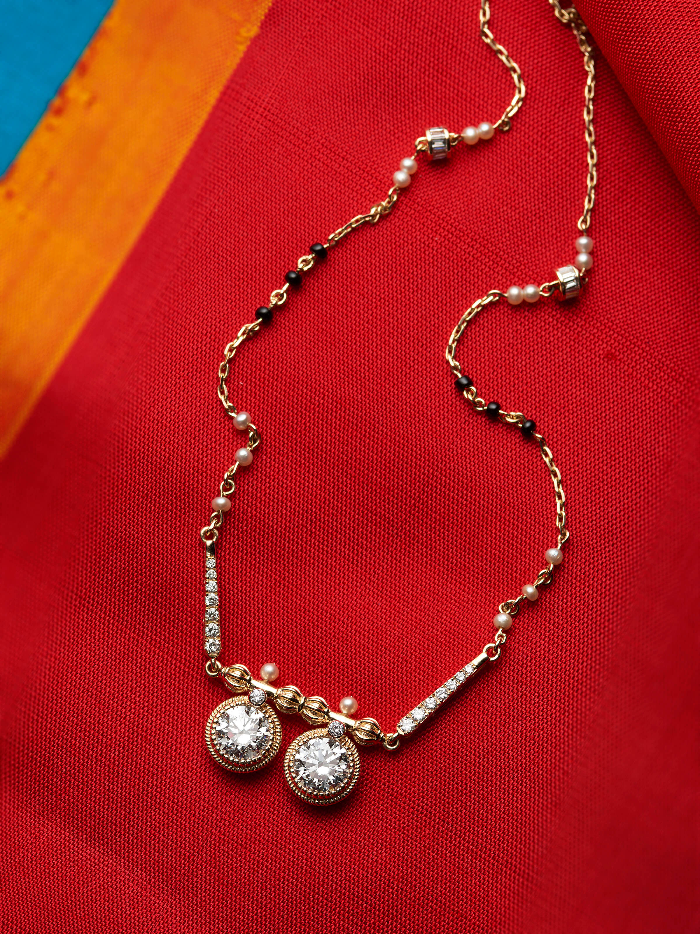 detail view of open setting 14 karat gold mangalsutra pendant