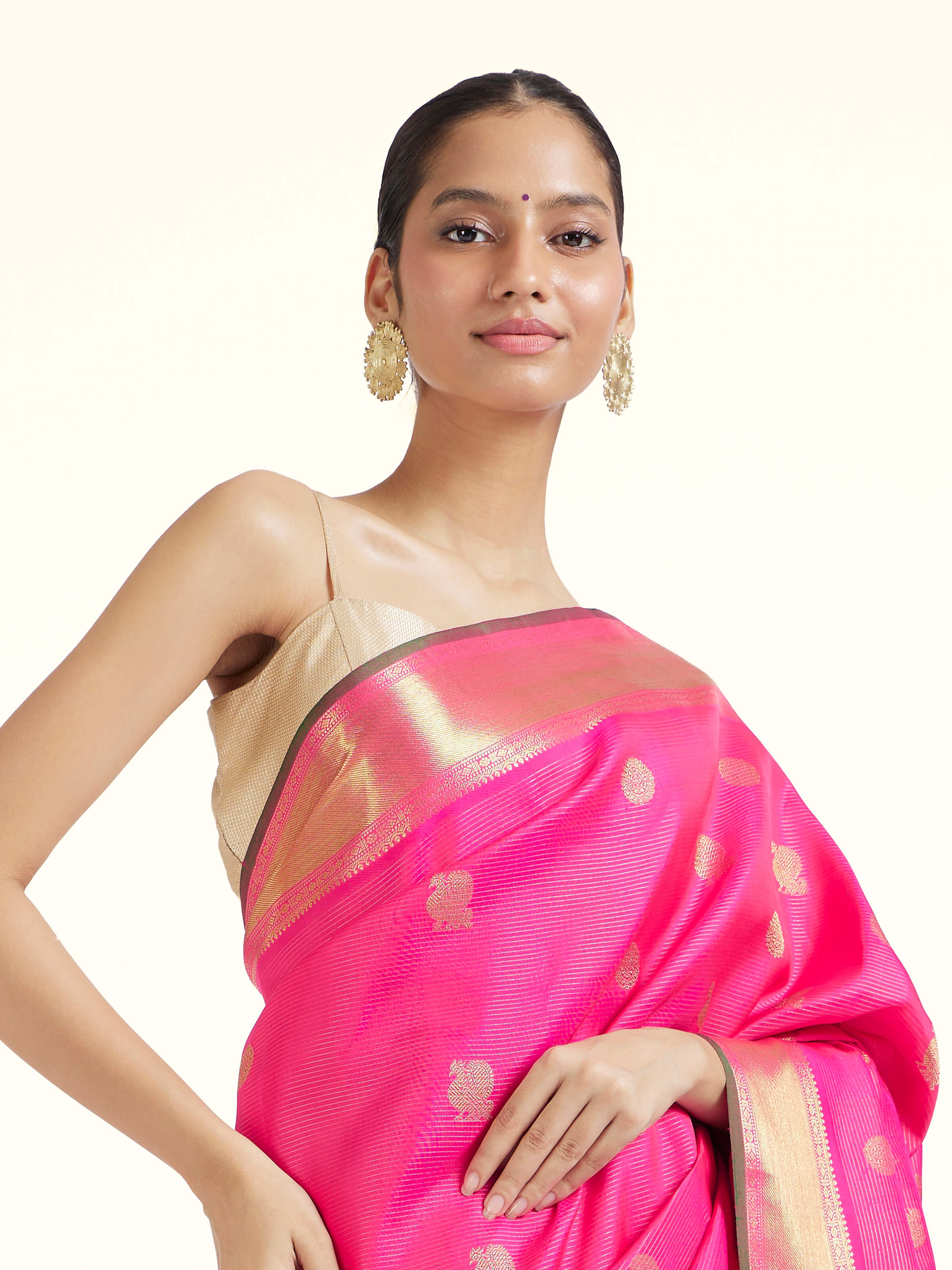 Angled view of pink silk Kancheepuram saree highlighting intricate zari work