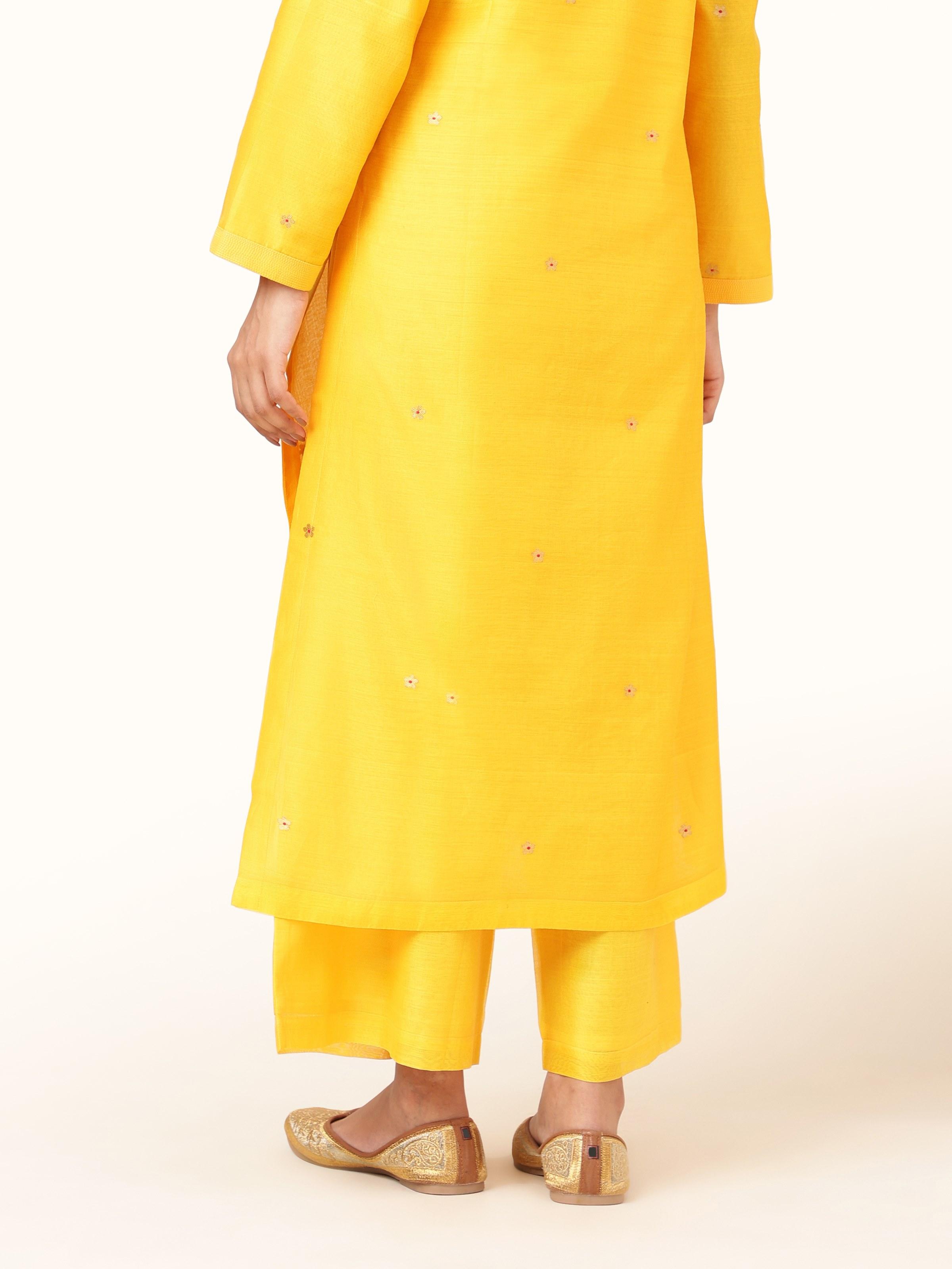 Back view capturing tailored design and soft fabric flow.