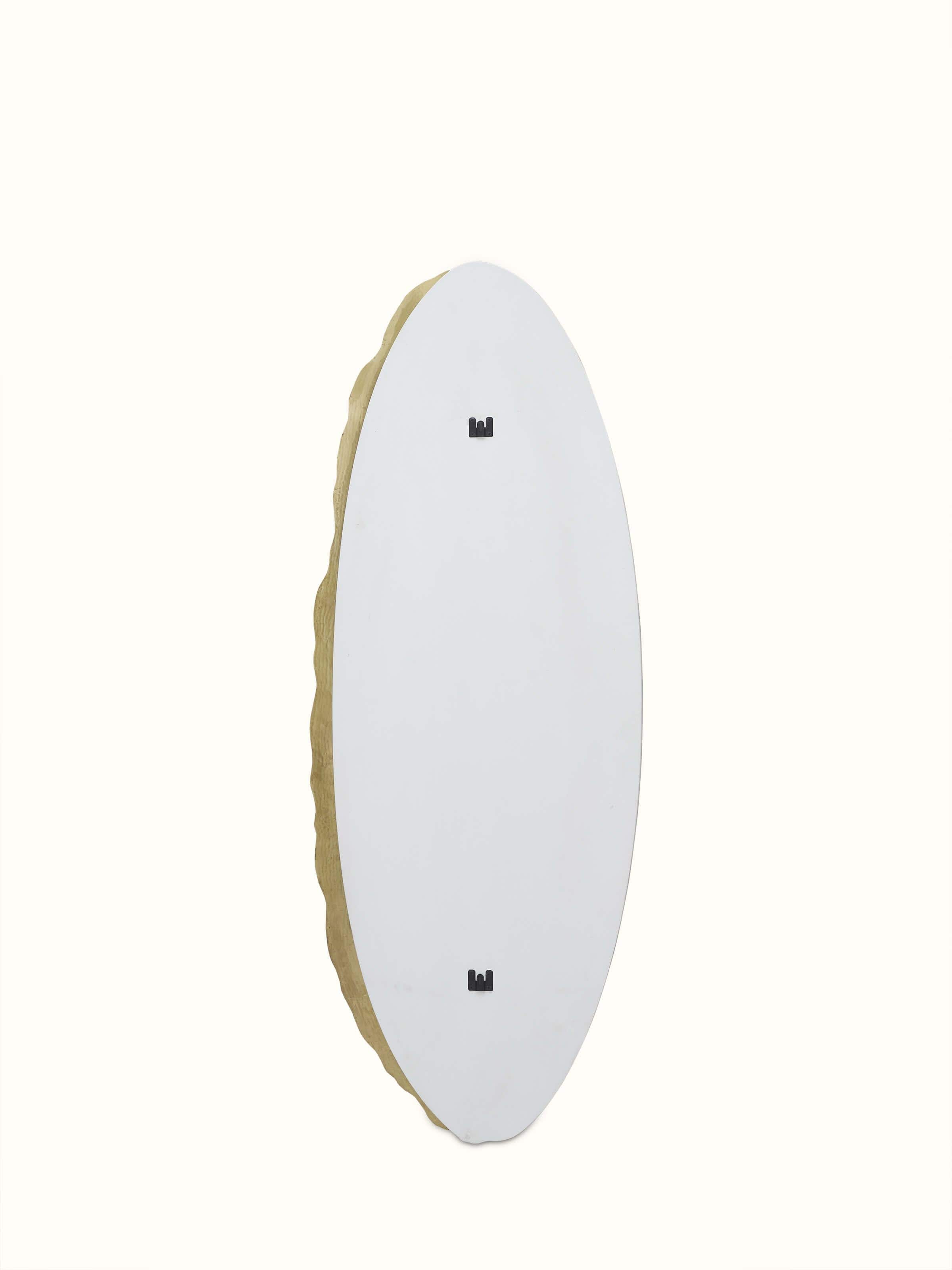 Back view of the brass & glass Thathera mirror, showing its structural design and support feature