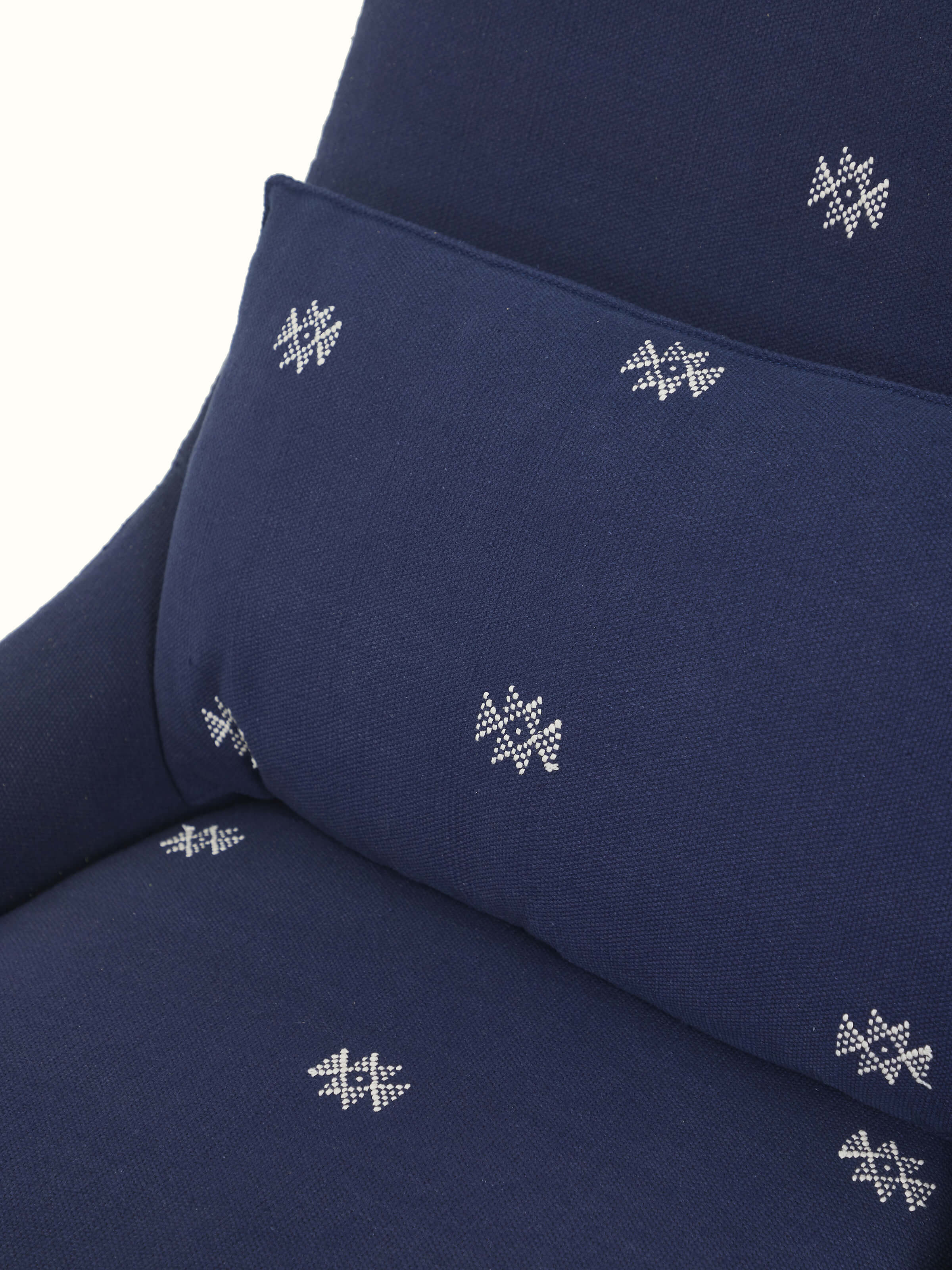 Detailed view of Upholstered Metal Wing Chair, emphasizing the fine upholstery and well-crafted metal frame