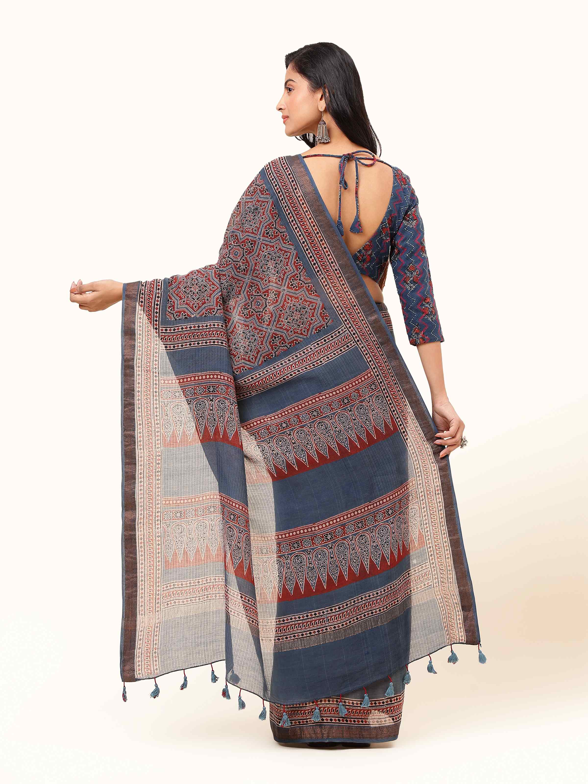 Back view of blue Maheshwari Ajrakh block printed saree displaying pleats and border design.