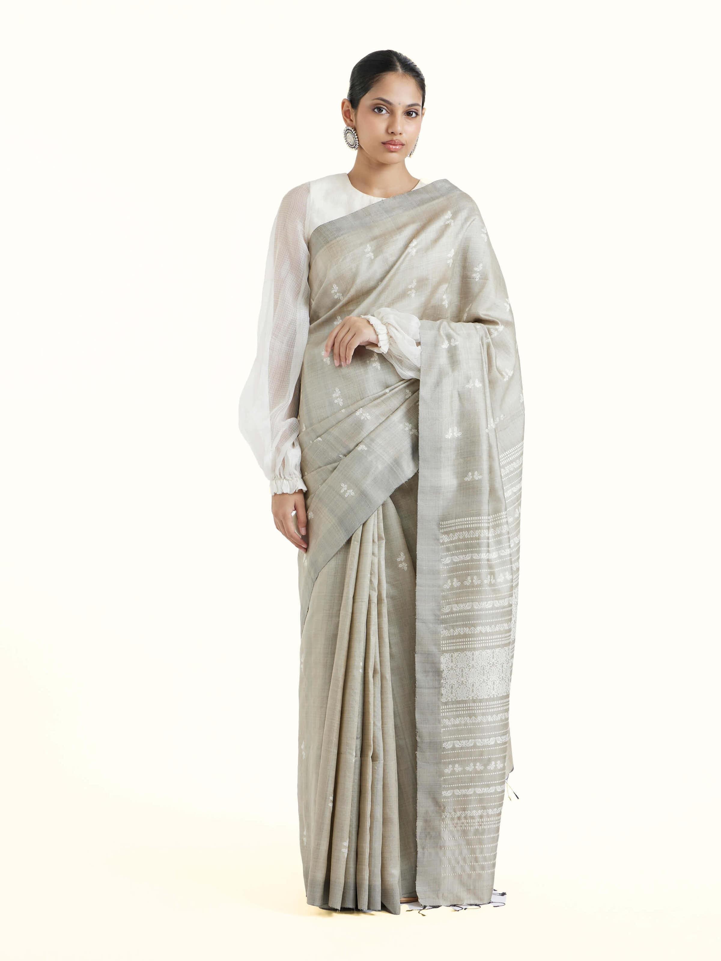 Front view of grey tussar silk Odisha ikat saree showcasing traditional woven motifs