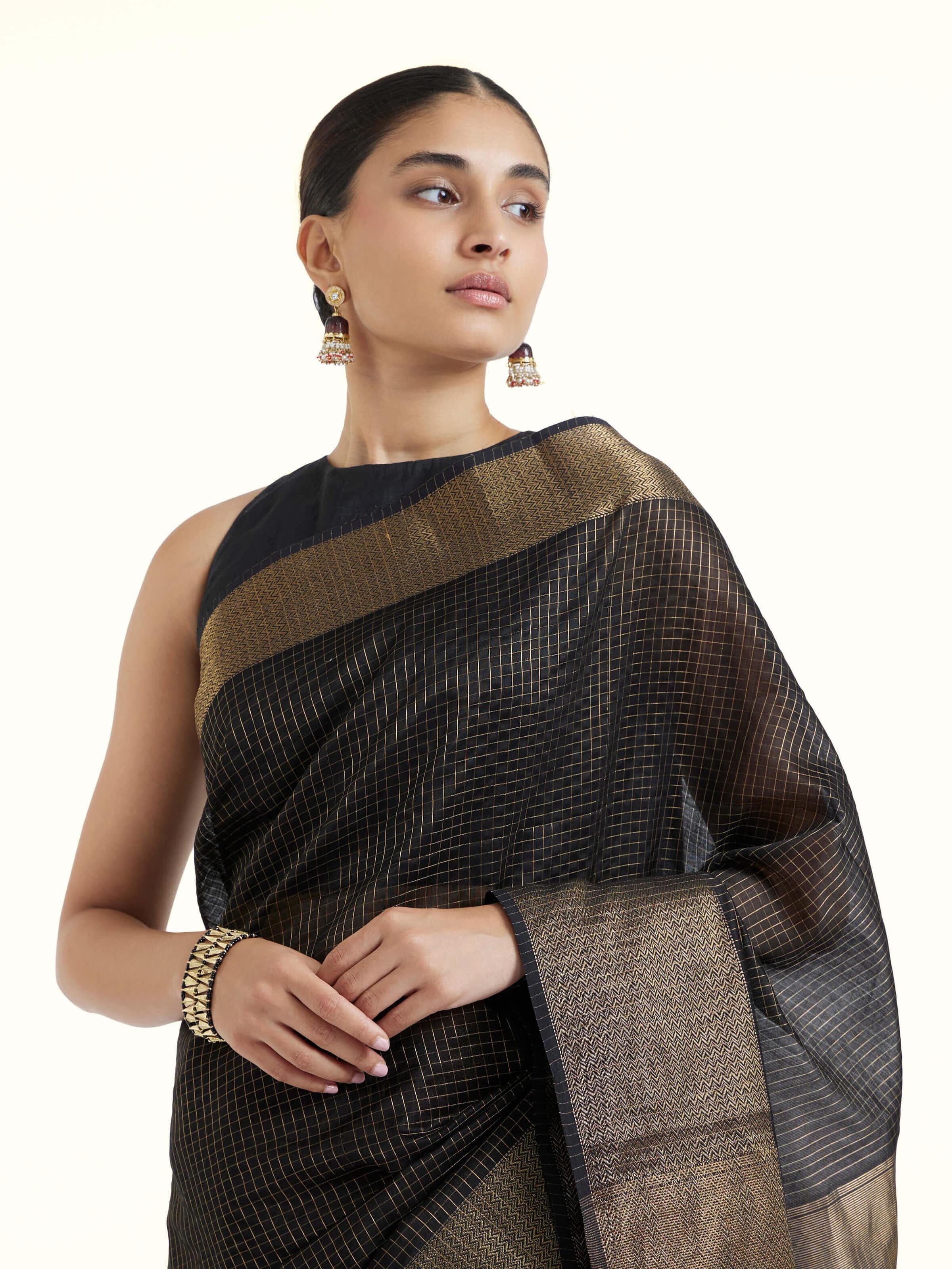 Angled view of black cotton silk Maheshwari saree highlighting woven patterns