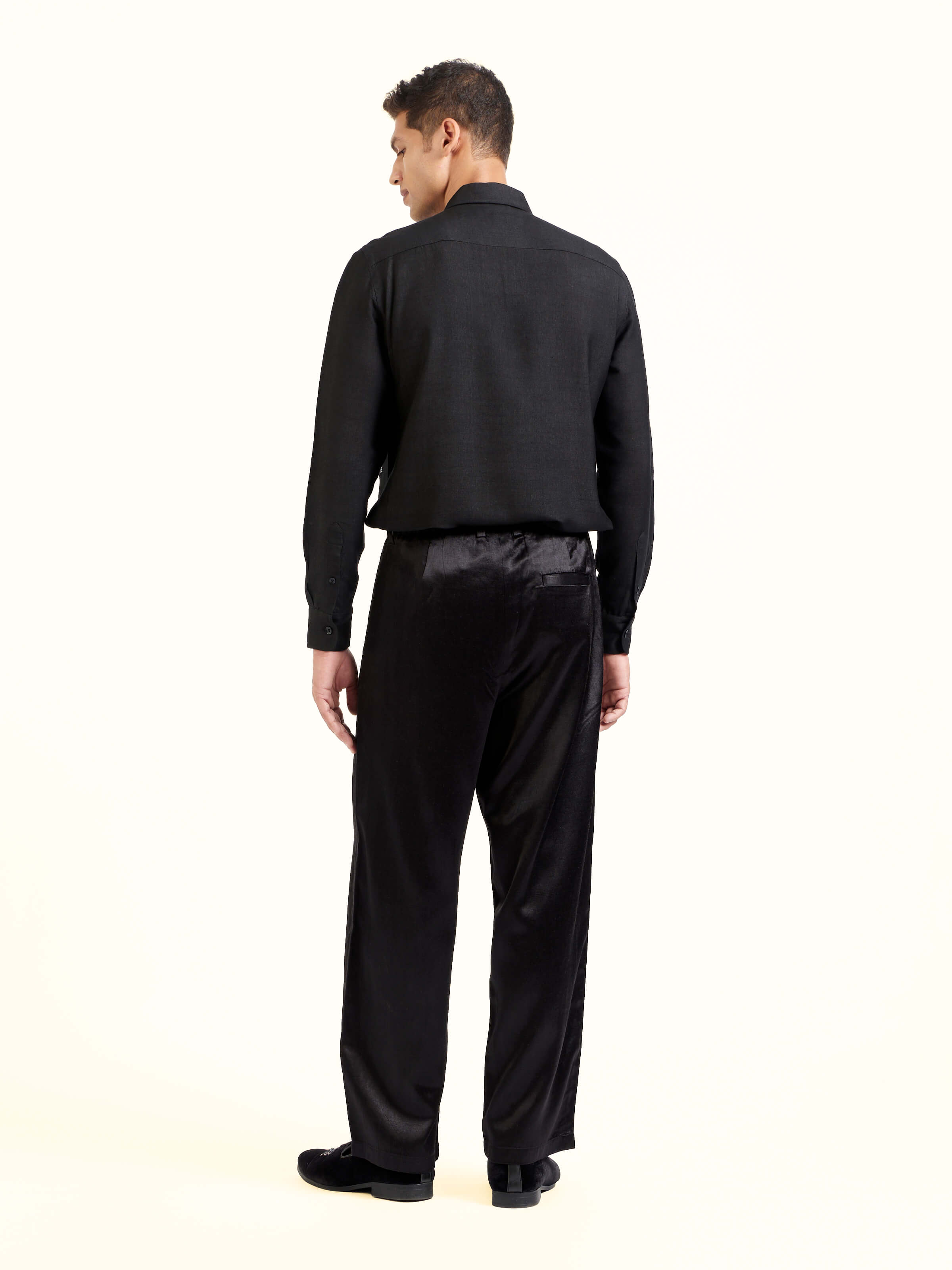 Back view of black straight cut mashru pants displaying fit and structure