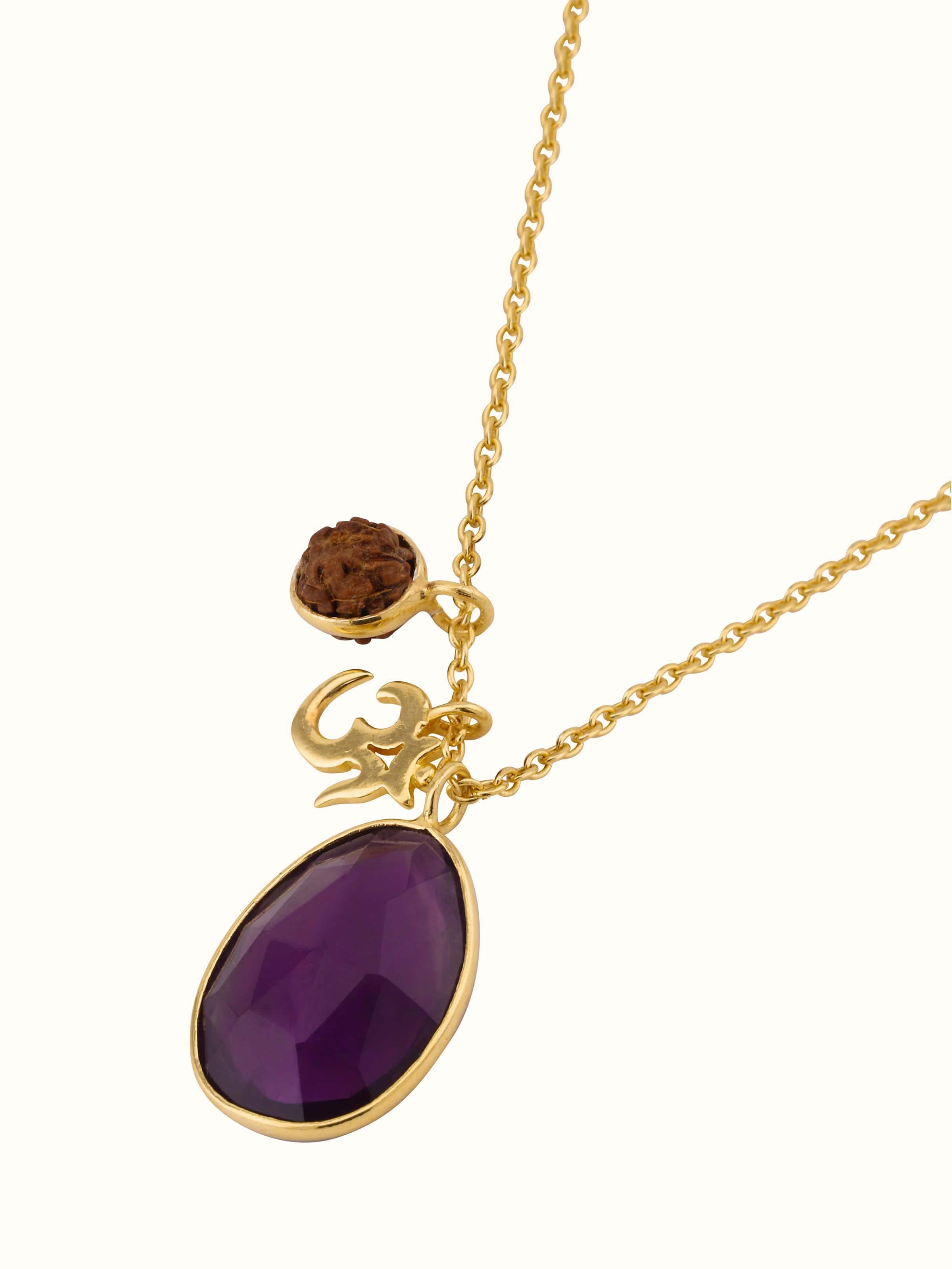 Overhead view of Rudraksha, Amethyst and Om charm necklace with gold-plated silver chain