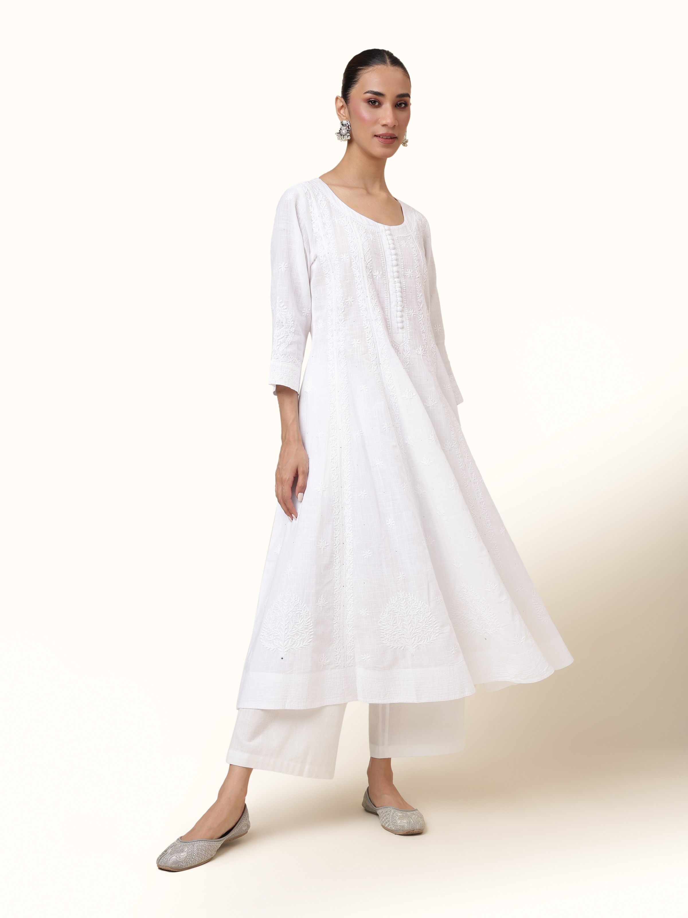 Front view presenting the soft white cotton Anarkali kurta with detailed Chikankari and shimmering Mukaish work.