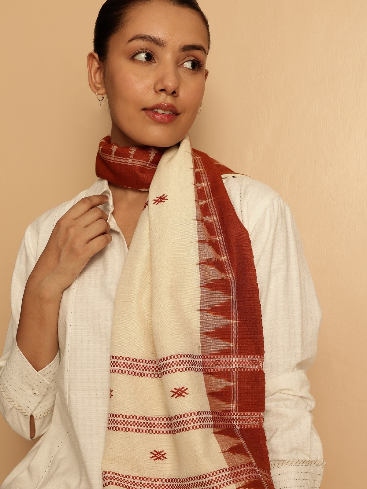 Lifestyle image of maroon cotton silk stole draped over shoulders for a festive look