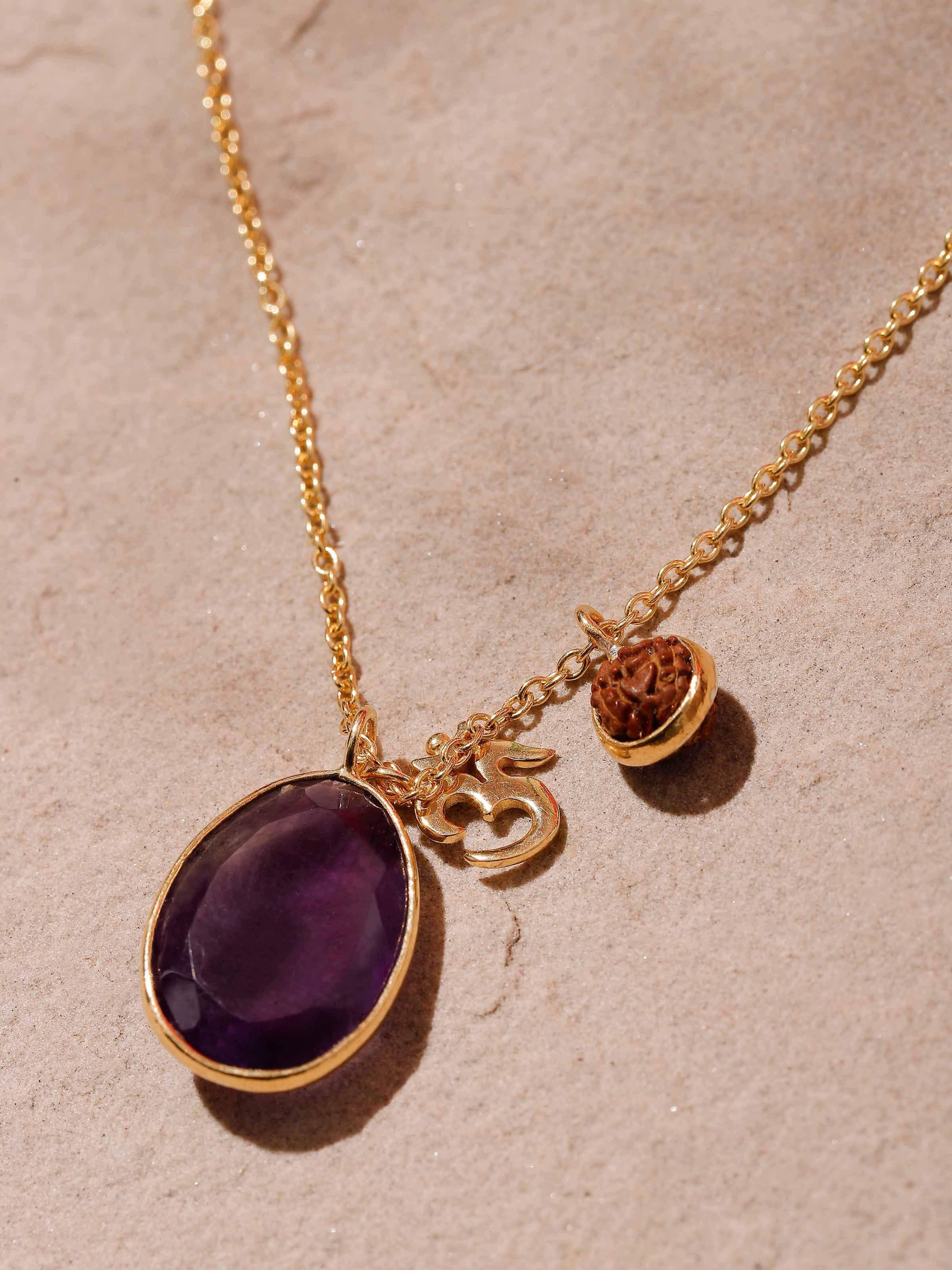 Detail shot highlighting Rudraksha bead, Amethyst gemstones and Om charm in gold-plated silver necklace
