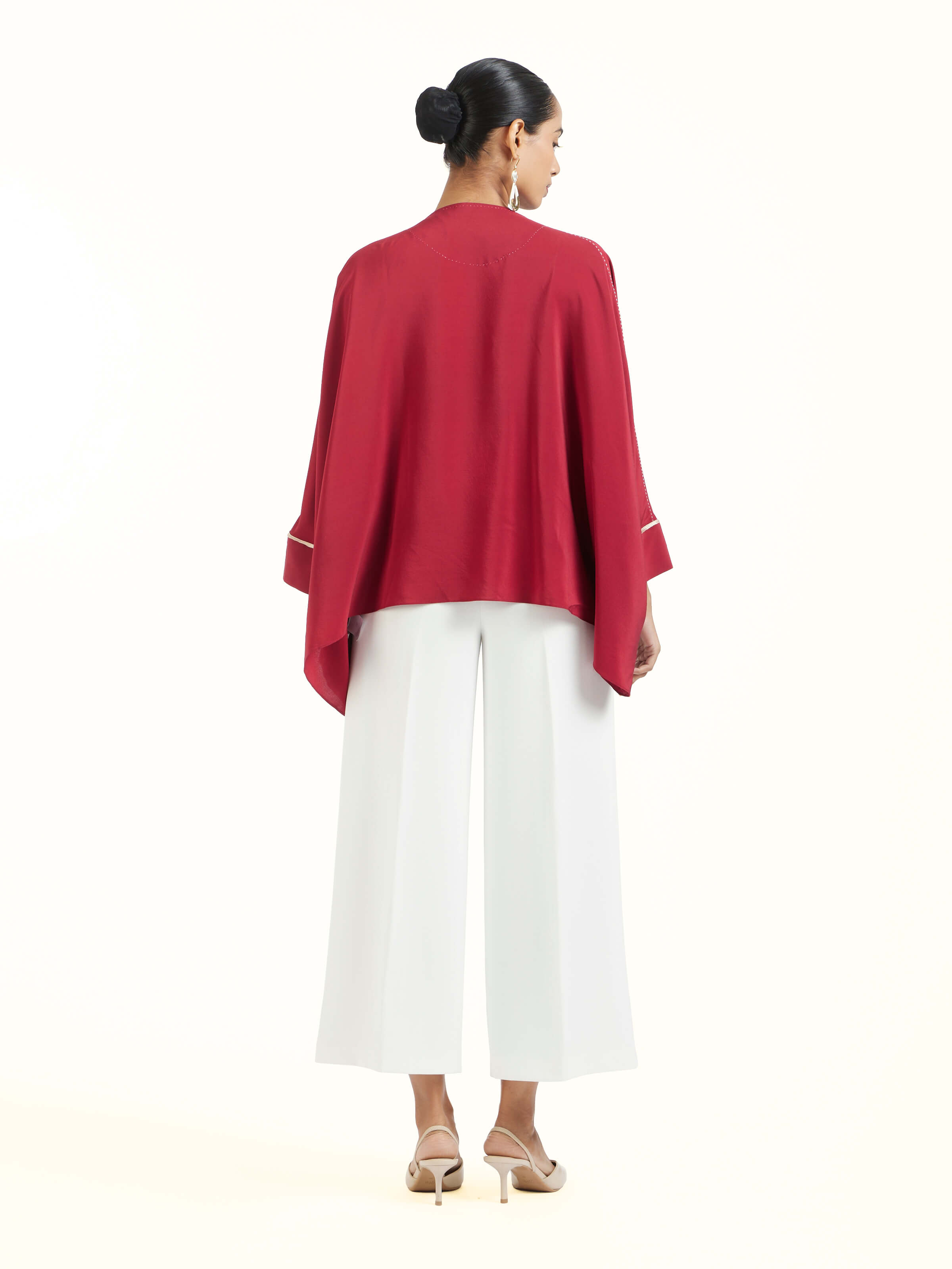 Back view of red silk handloom top displaying structured design