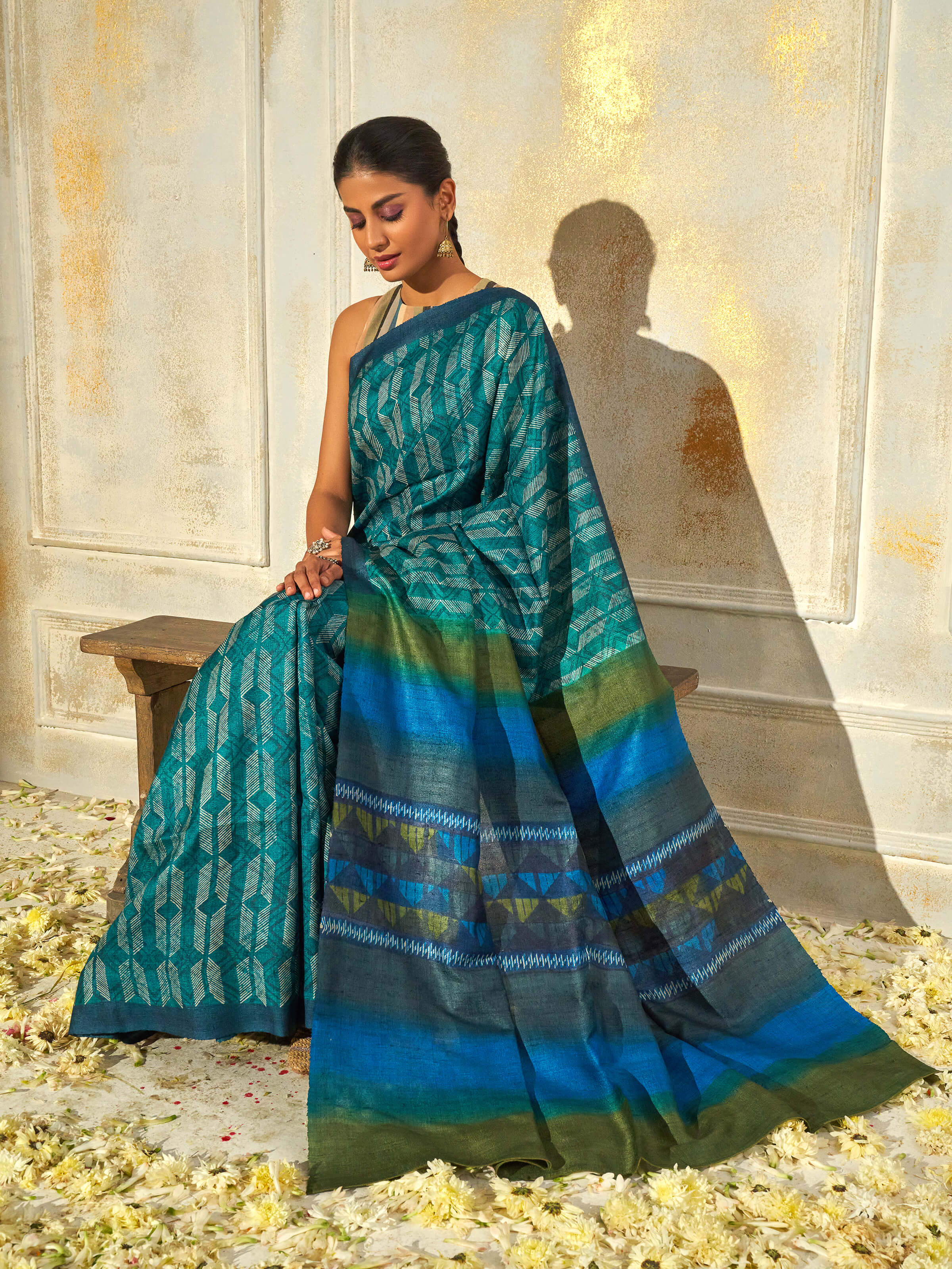 Angled view of sea green tussar silk discharge block printed saree highlighting block print artistry
