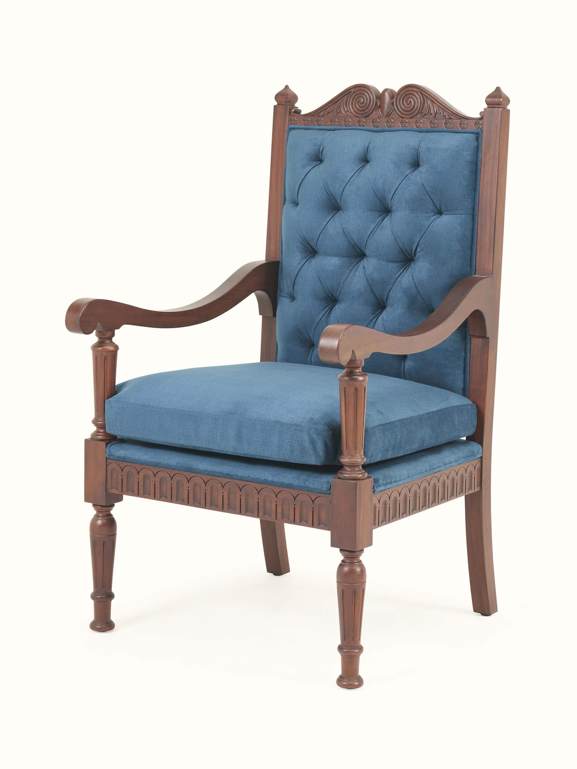 Angle view of upholstered mahogany wood arm chair showcasing sculpted legs and curved armrests