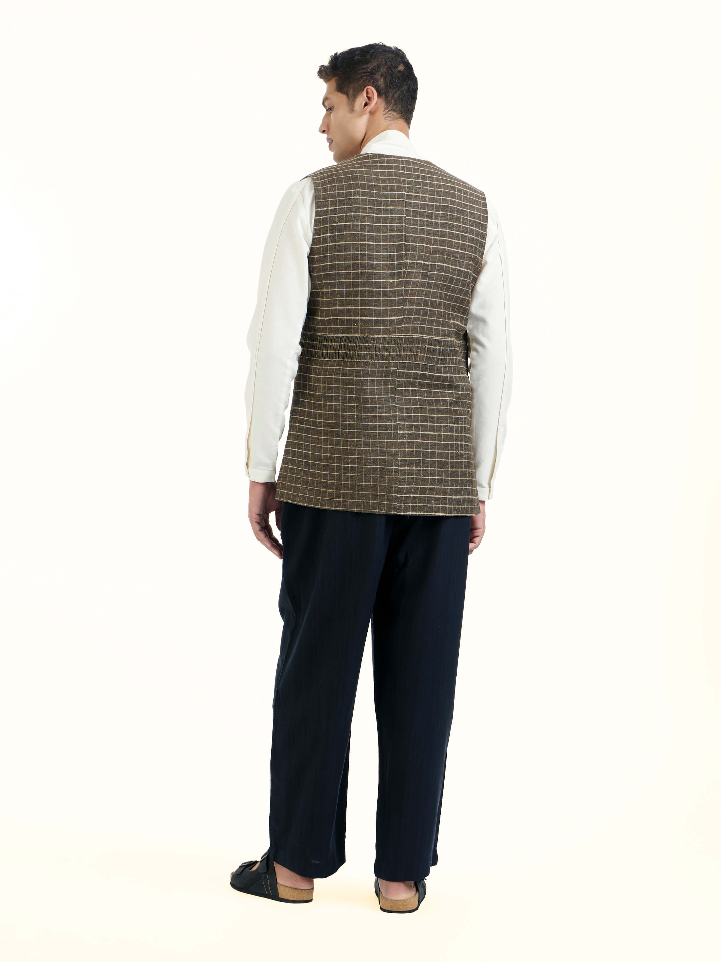 Back view of brown handloom sleeveless jacket with clean structured finish