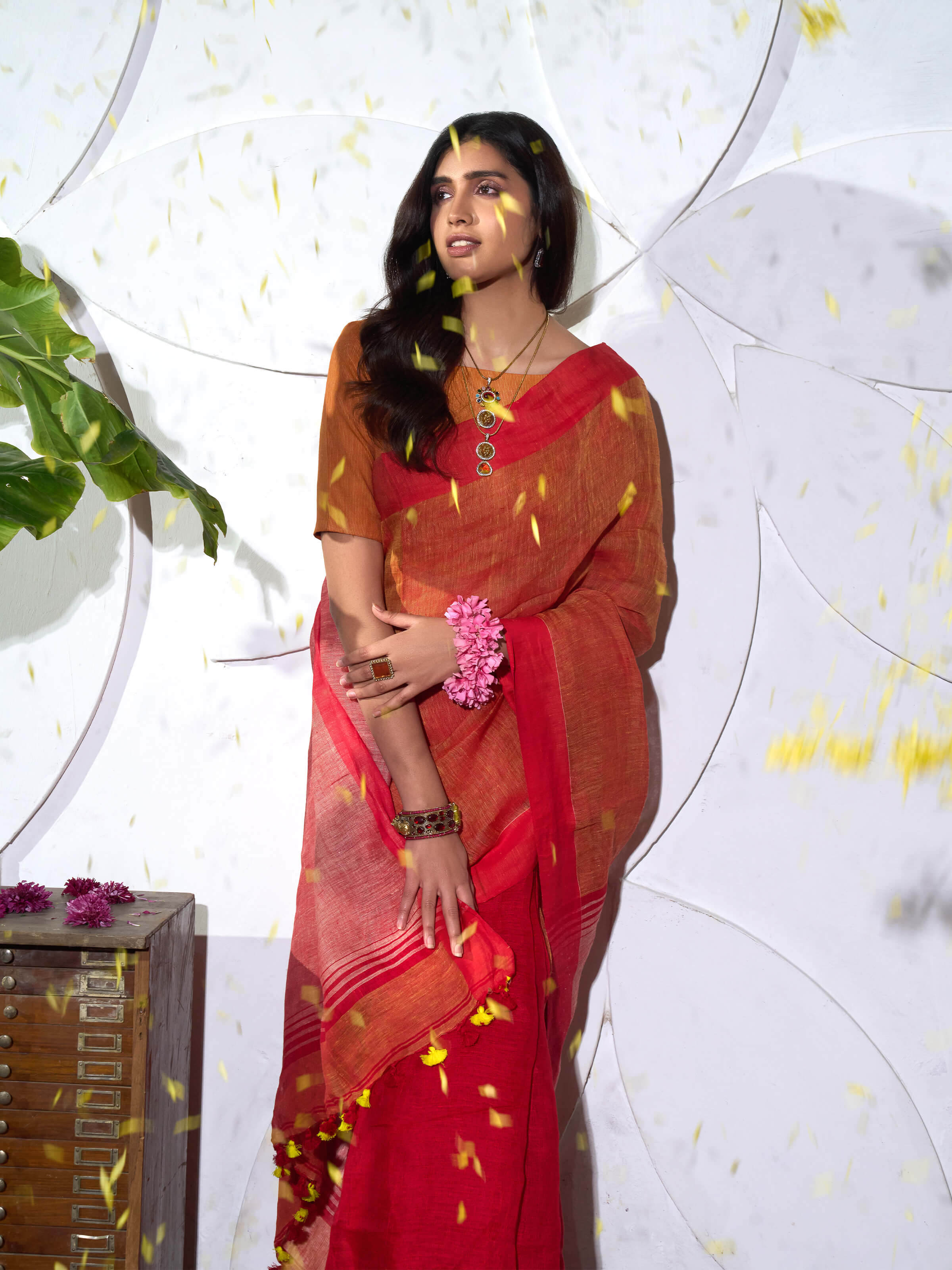 Detail view of orange linen saree showcasing fabric texture and craftsmanship