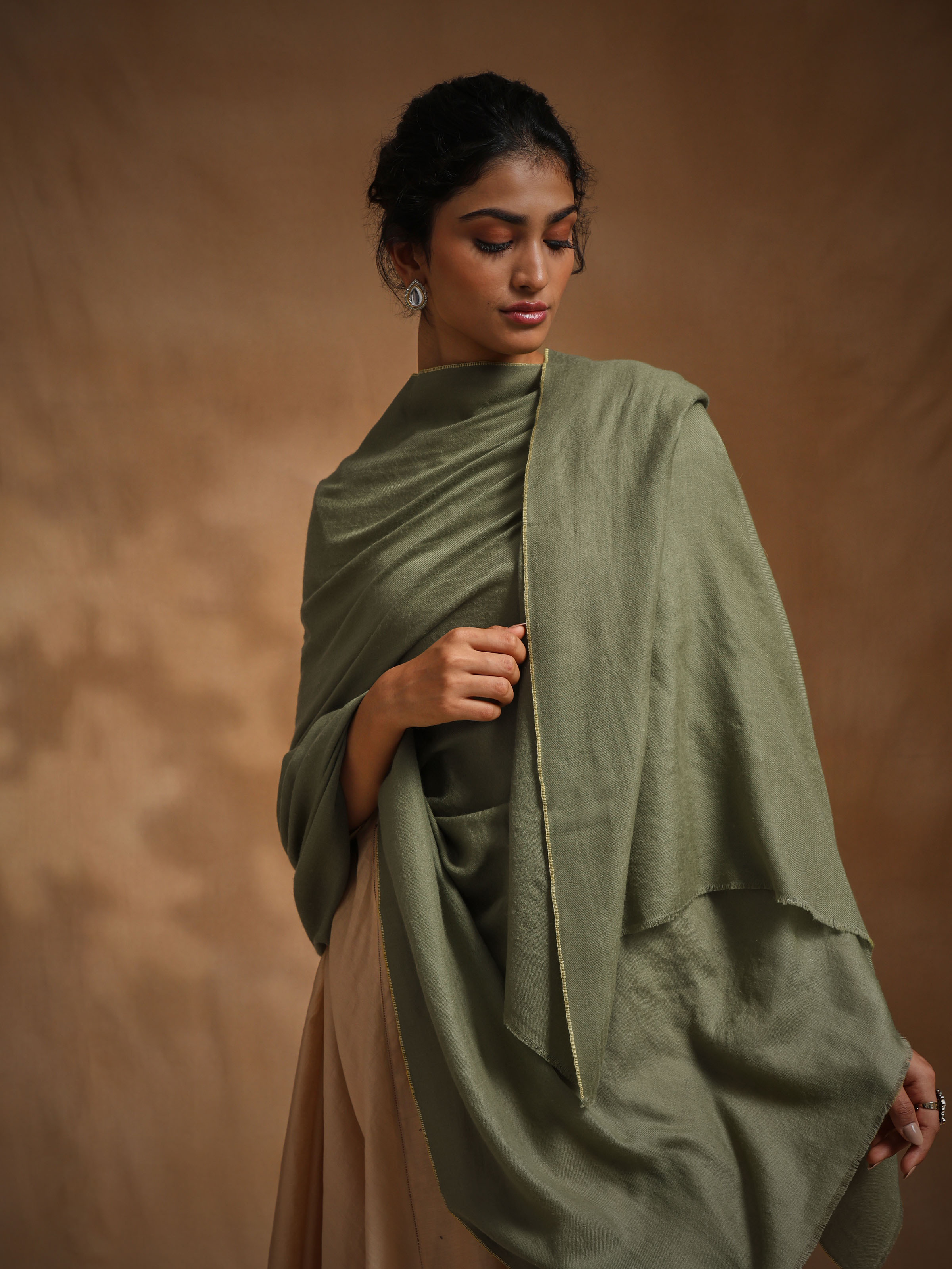 Angled view of green cashmere Kaaj embroidered handwoven stole emphasizing craftsmanship and delicate motifs