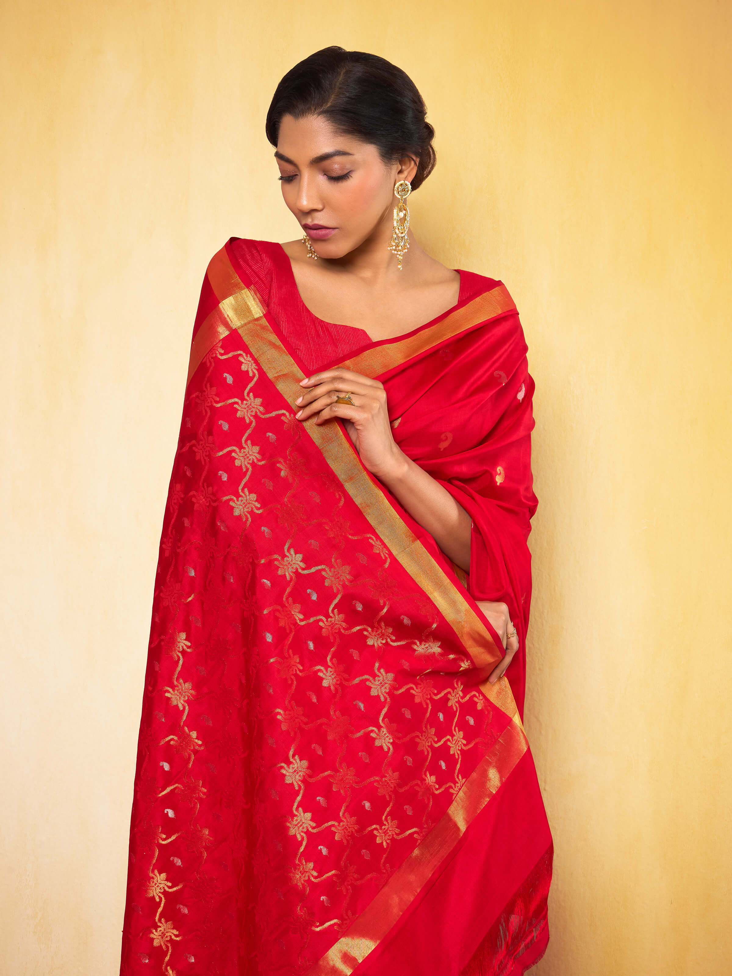 Front view displaying red Jamdani saree with detailed pallu and delicate traditional weaving.