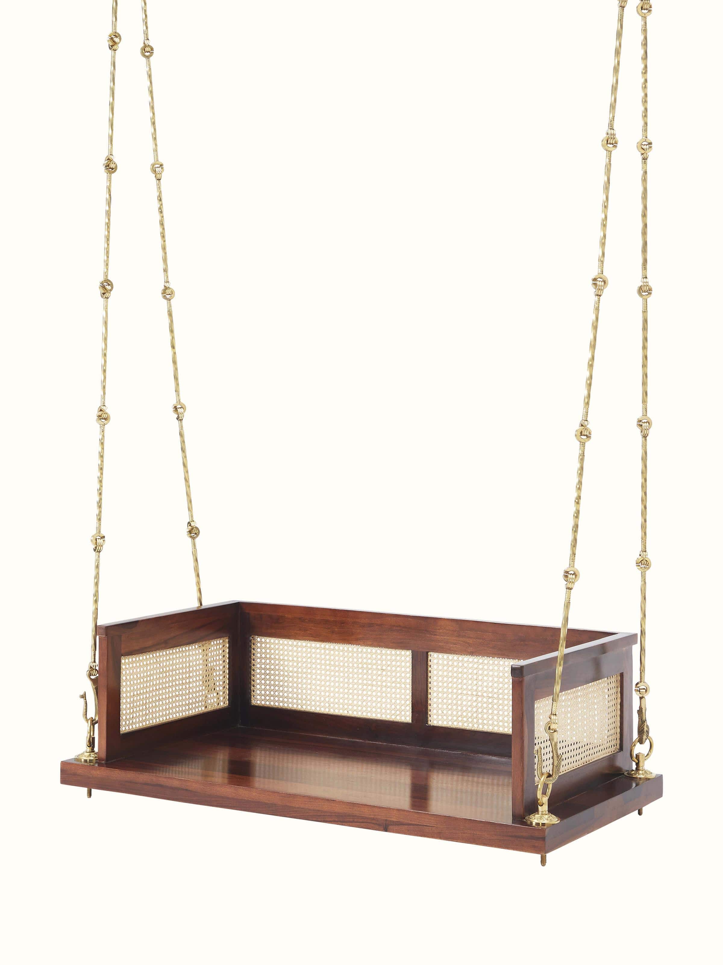 Side view of the Sheesham wood and cane swing, highlighting the intricate cane weaving and solid wood frame