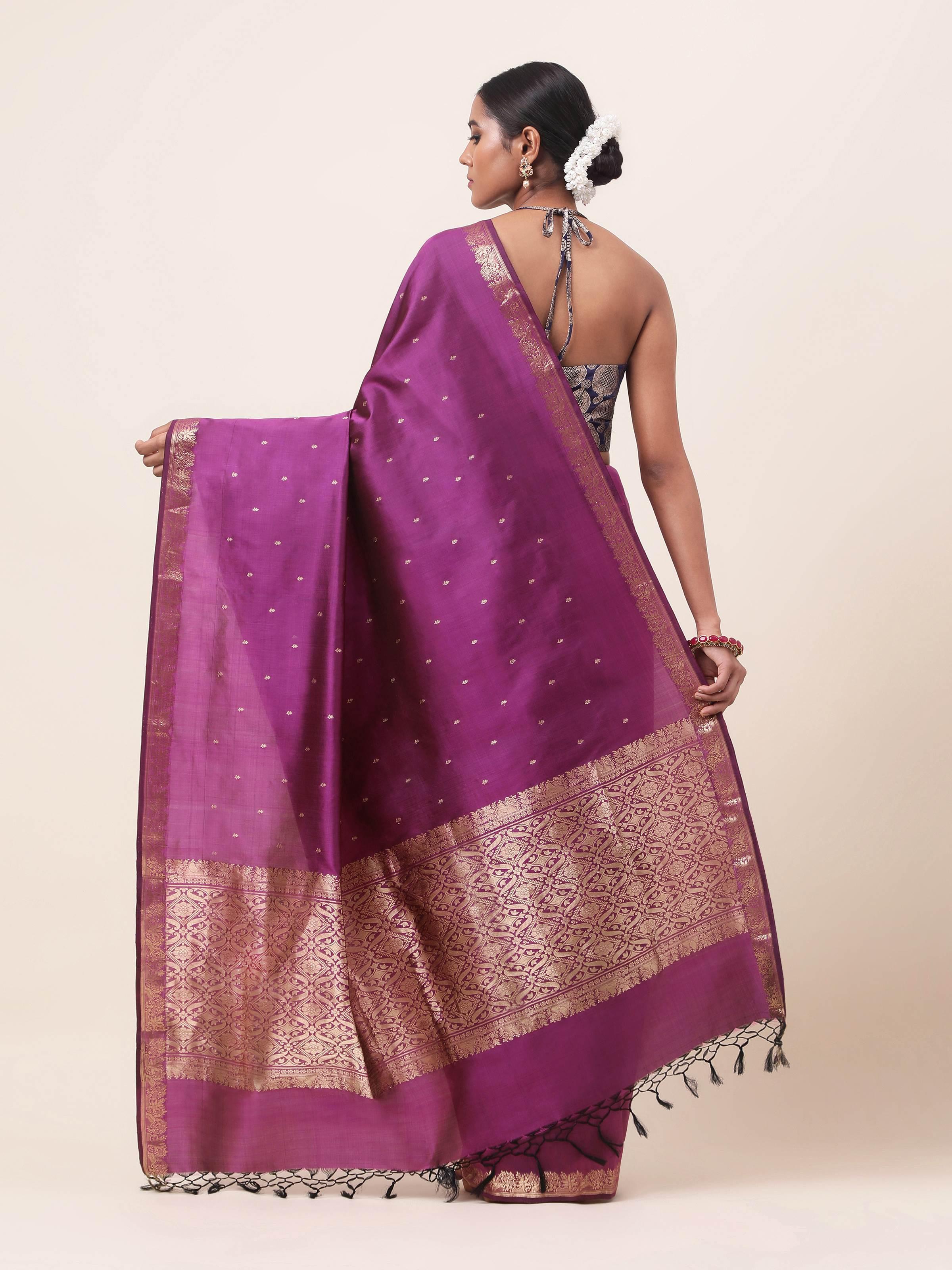 Back view of Banarasi silk saree with flowing pallu and traditional zari work.