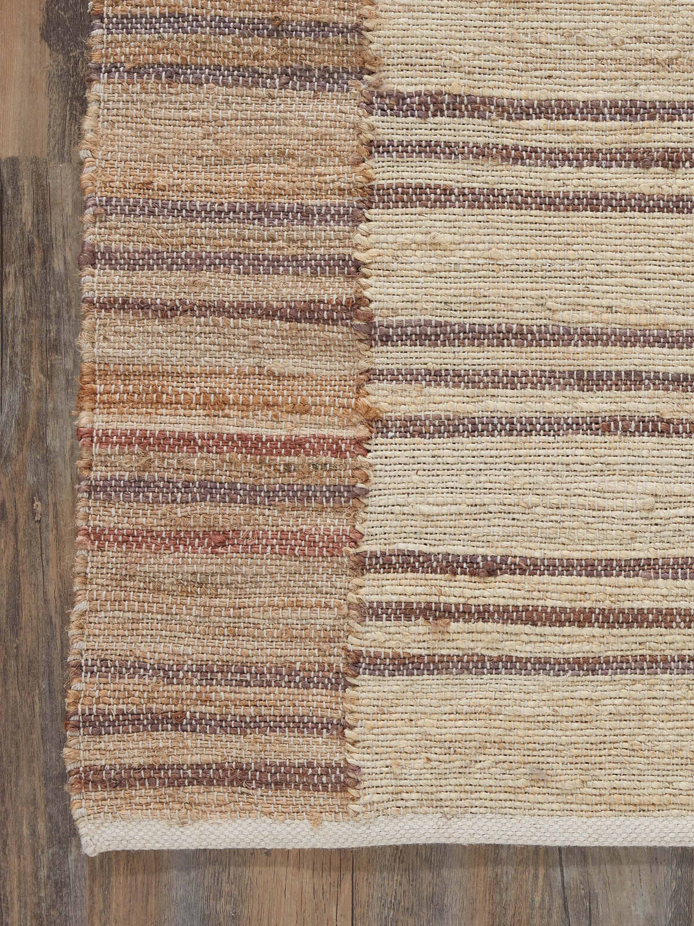 Side detail of Textured Stripes Lawan Jute Rug showing fine weave and earthy color tones