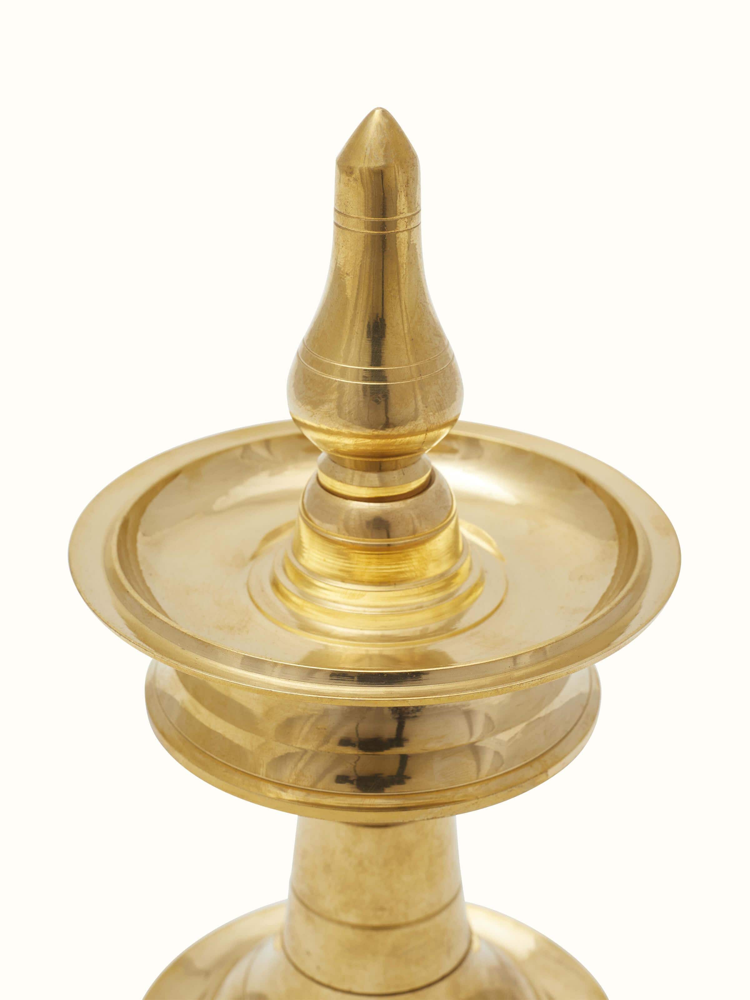 Detailed view of traditional brass samai vilakku stand diya highlighting the intricate metalwork and elegant design