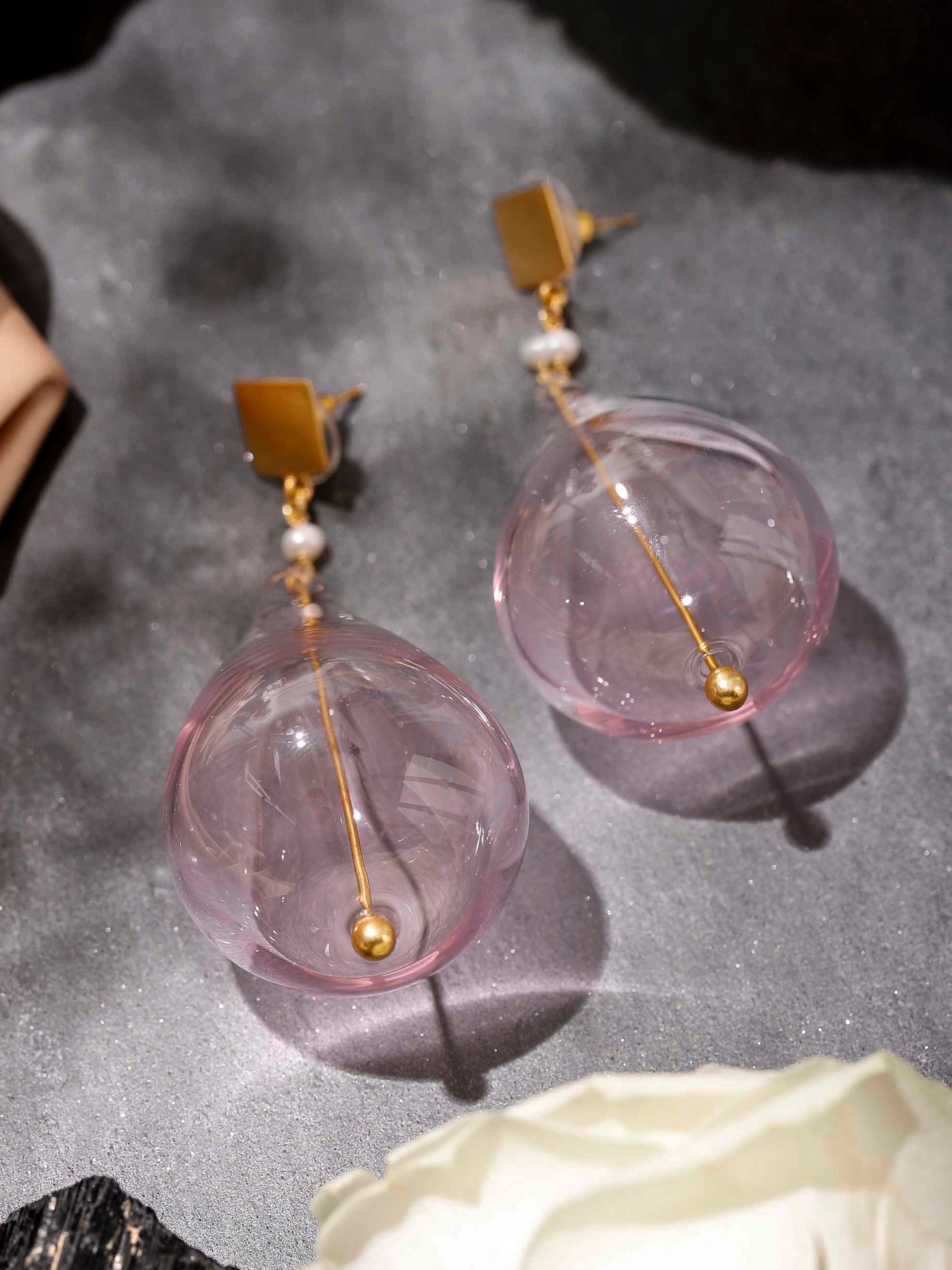 Lifestyle view of silver flame glass drop earrings