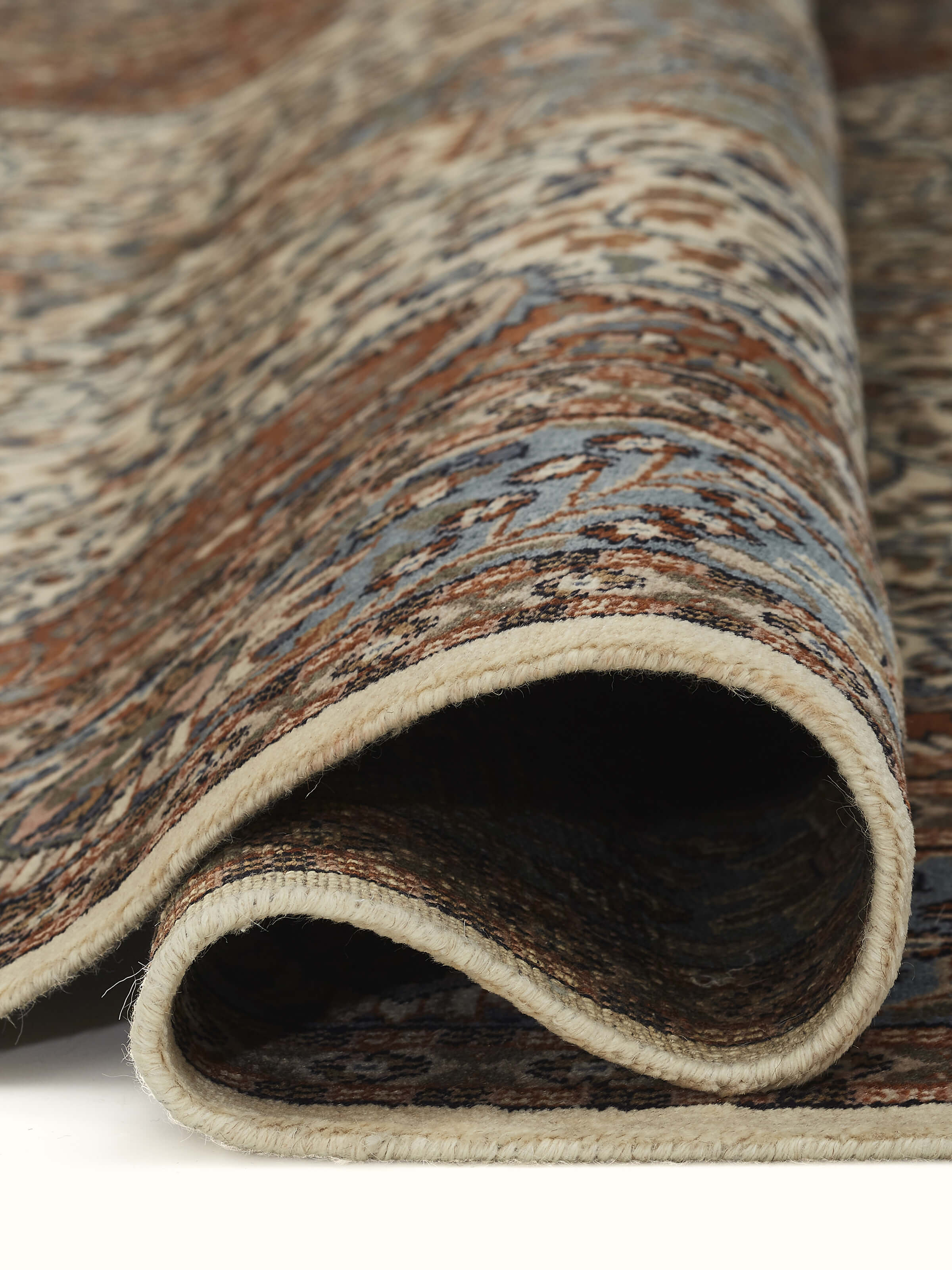 A corner of the carpet highlights the fine border design and weaving precision.