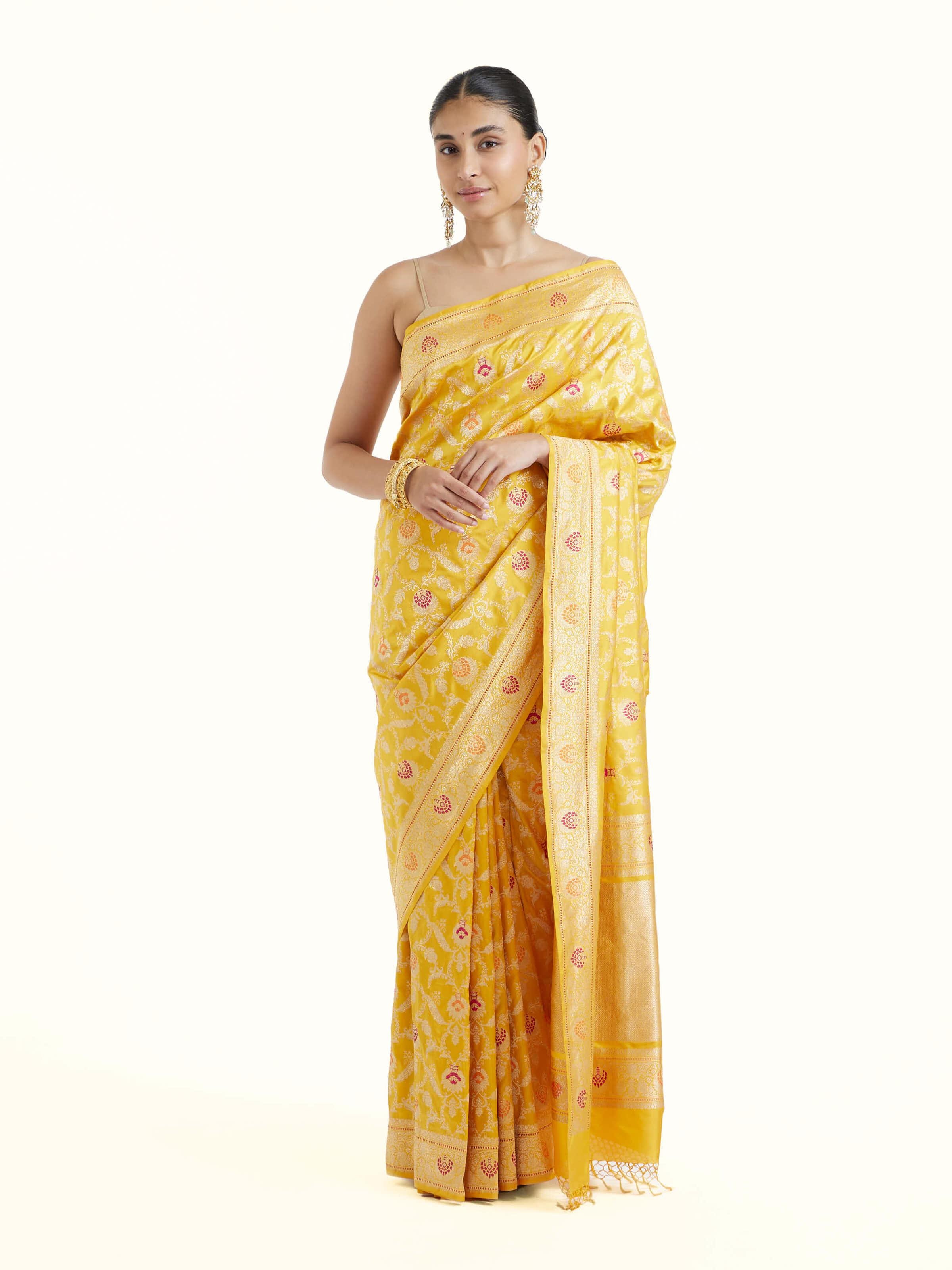 Front view of yellow Banarasi silk kadwa jaal saree with rich all-over zari motifs