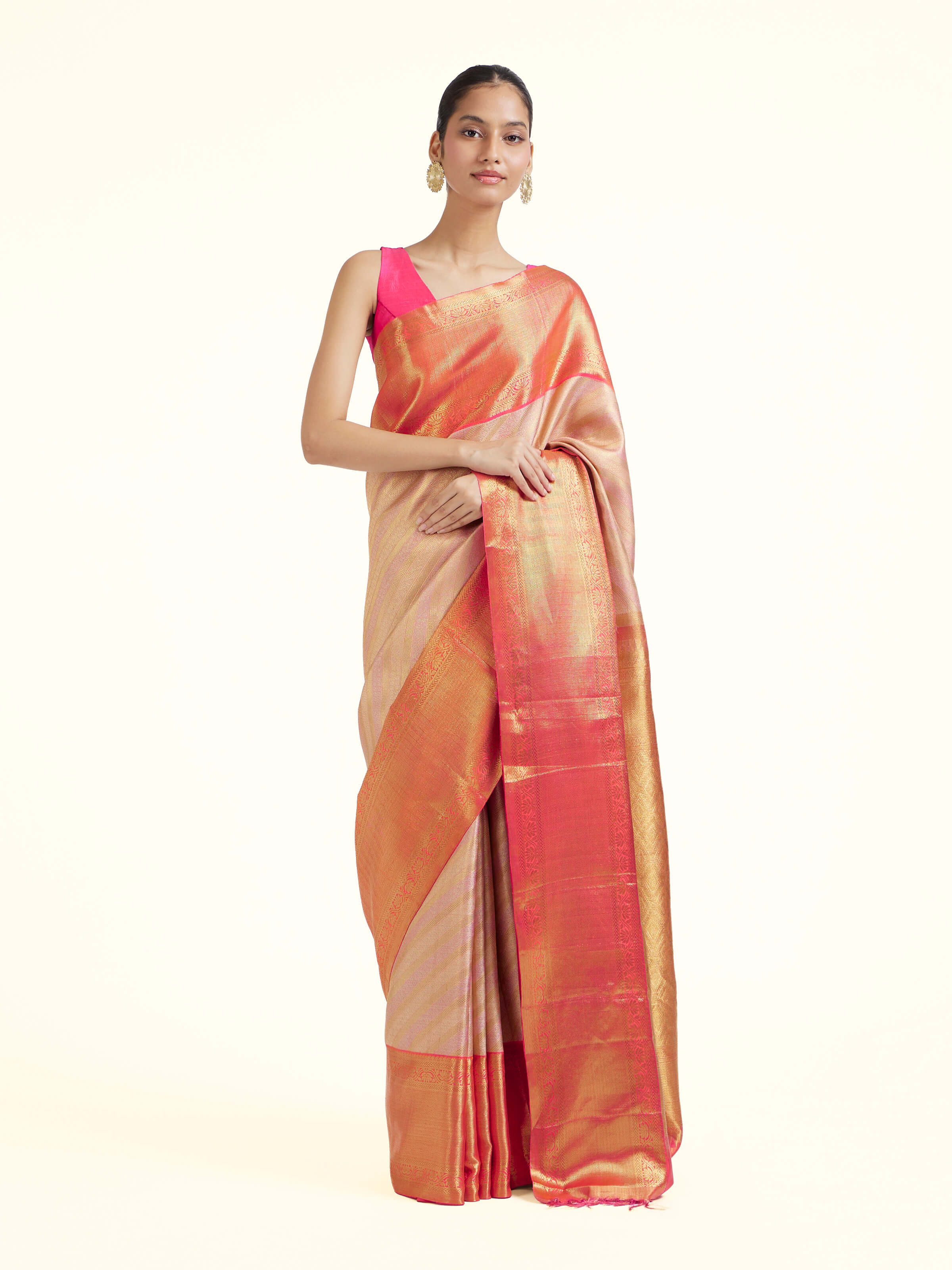 Front view of light pink silk Kancheepuram saree with rich zari woven motifs