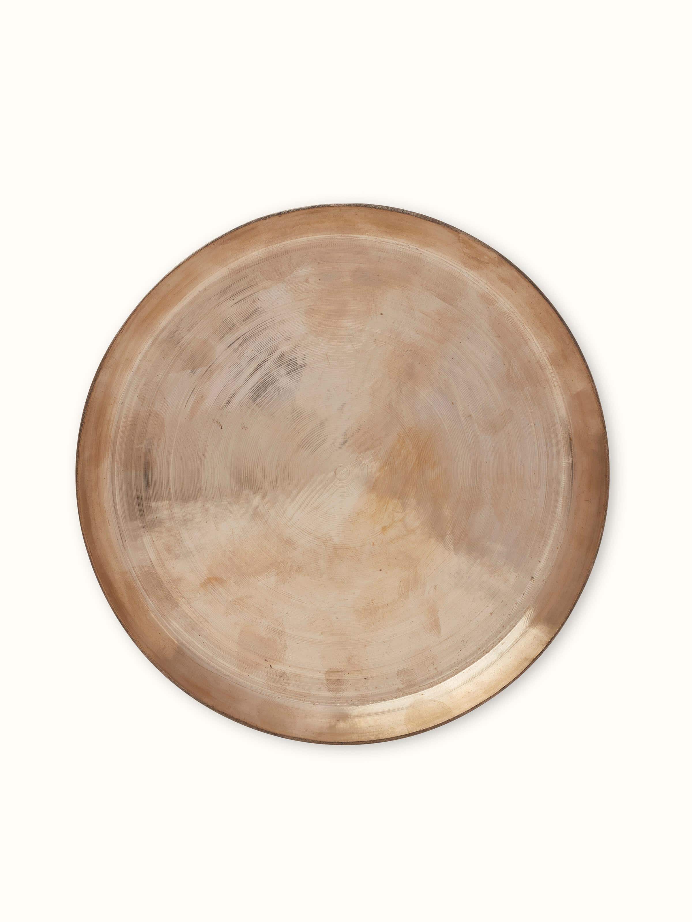Front view of bell metal dinner plate highlighting polished surface and elegant design